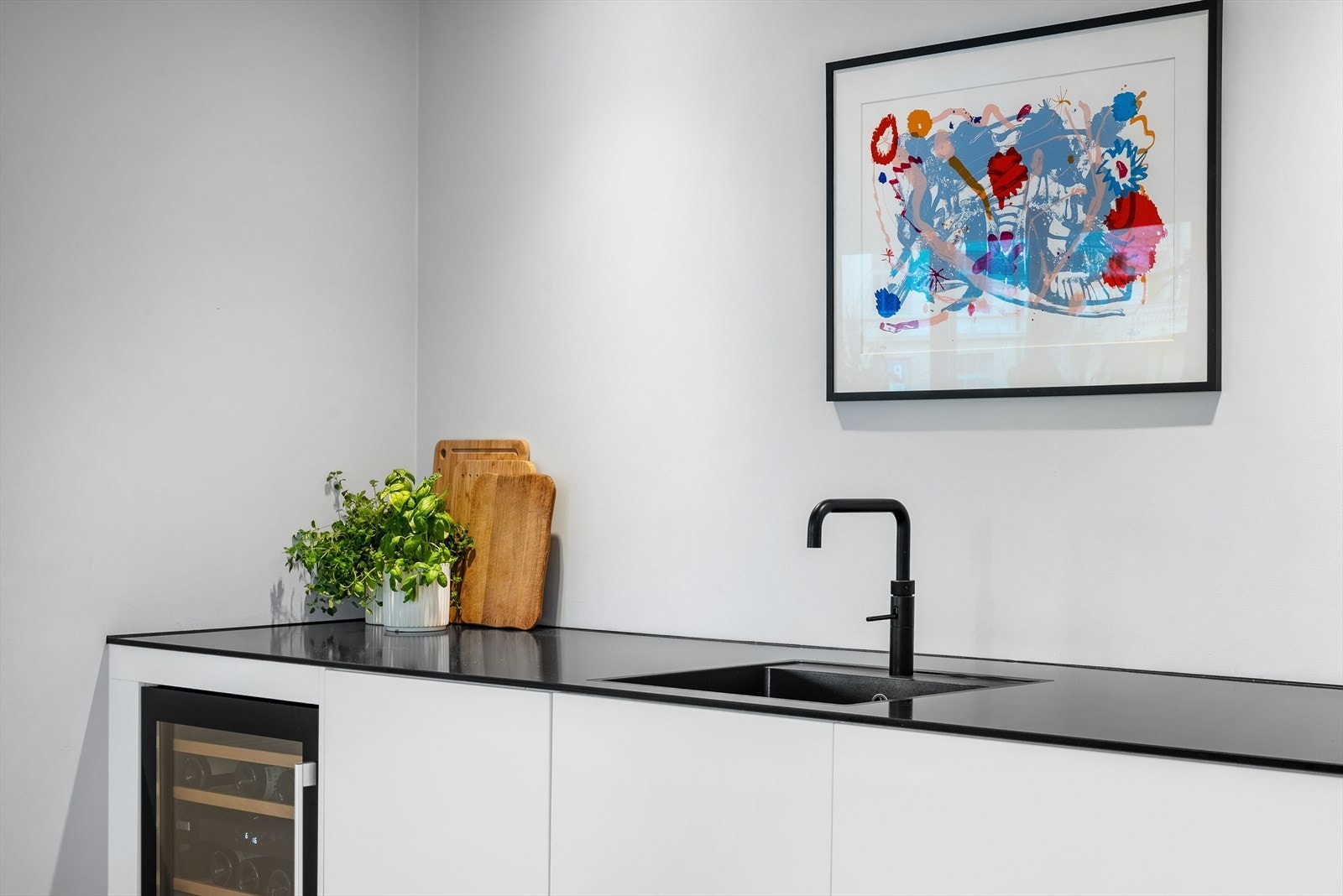 Stort integrert vinskap under benk. Kjøkkenmoduler av typen Kvik XXL med ekstra store og dype skuffer samt benkeplate med dybde på hele 77 cm gir en svært god arbeidssone. Galleribilde