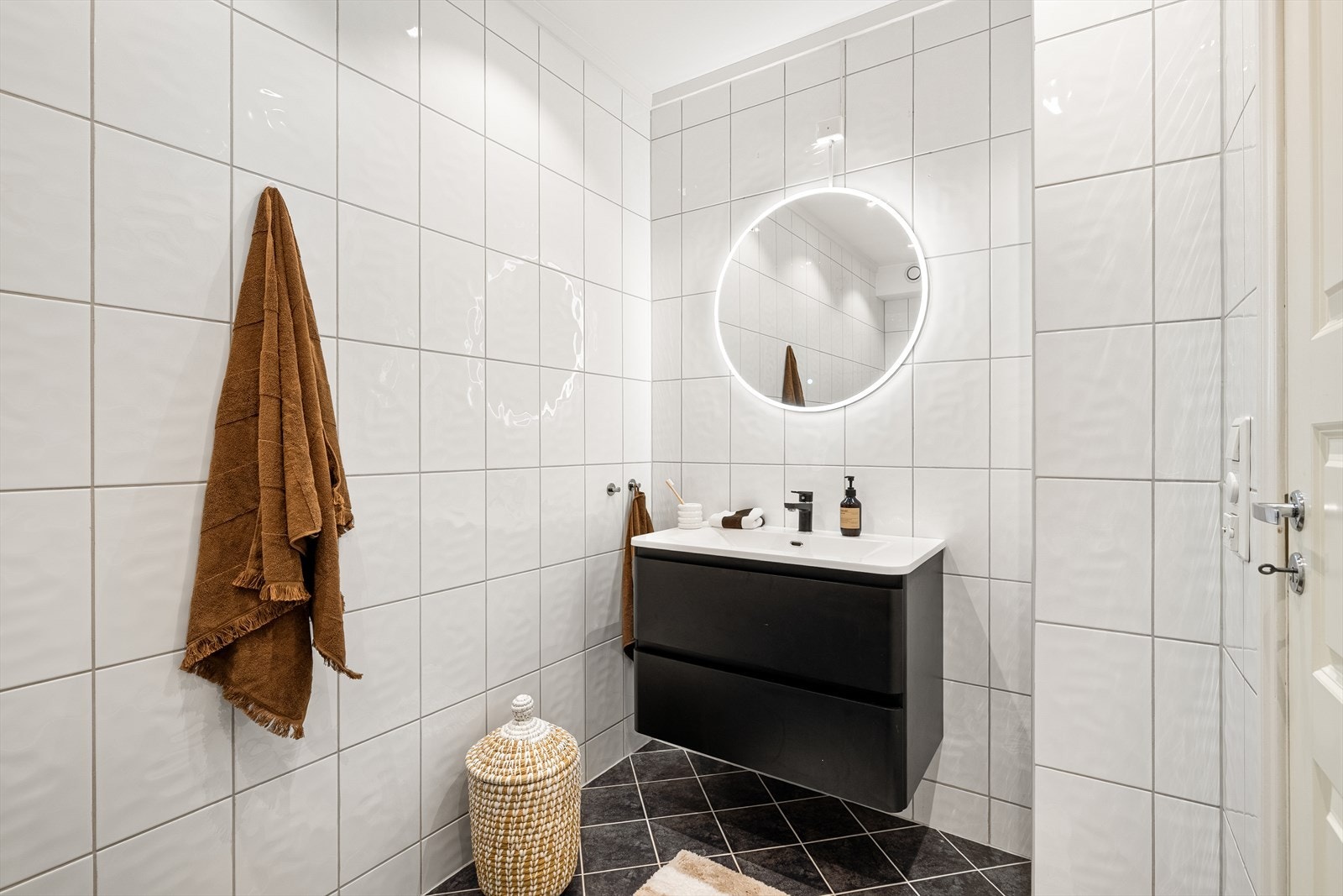 Badet inneholder helstøpt servant med skuffer, dusjkabinett og opplegg for vaskemaskin. Galleribilde