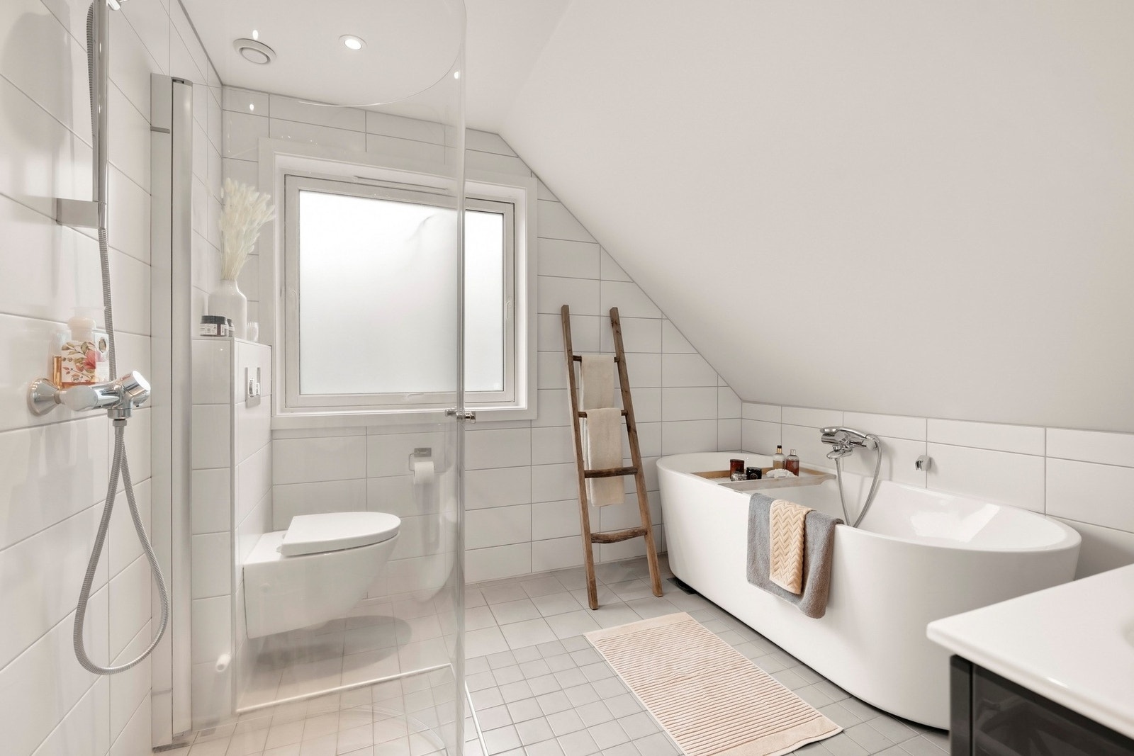 Badet har flislagt gulv med gulvvarme og flislagte overflater Galleribilde