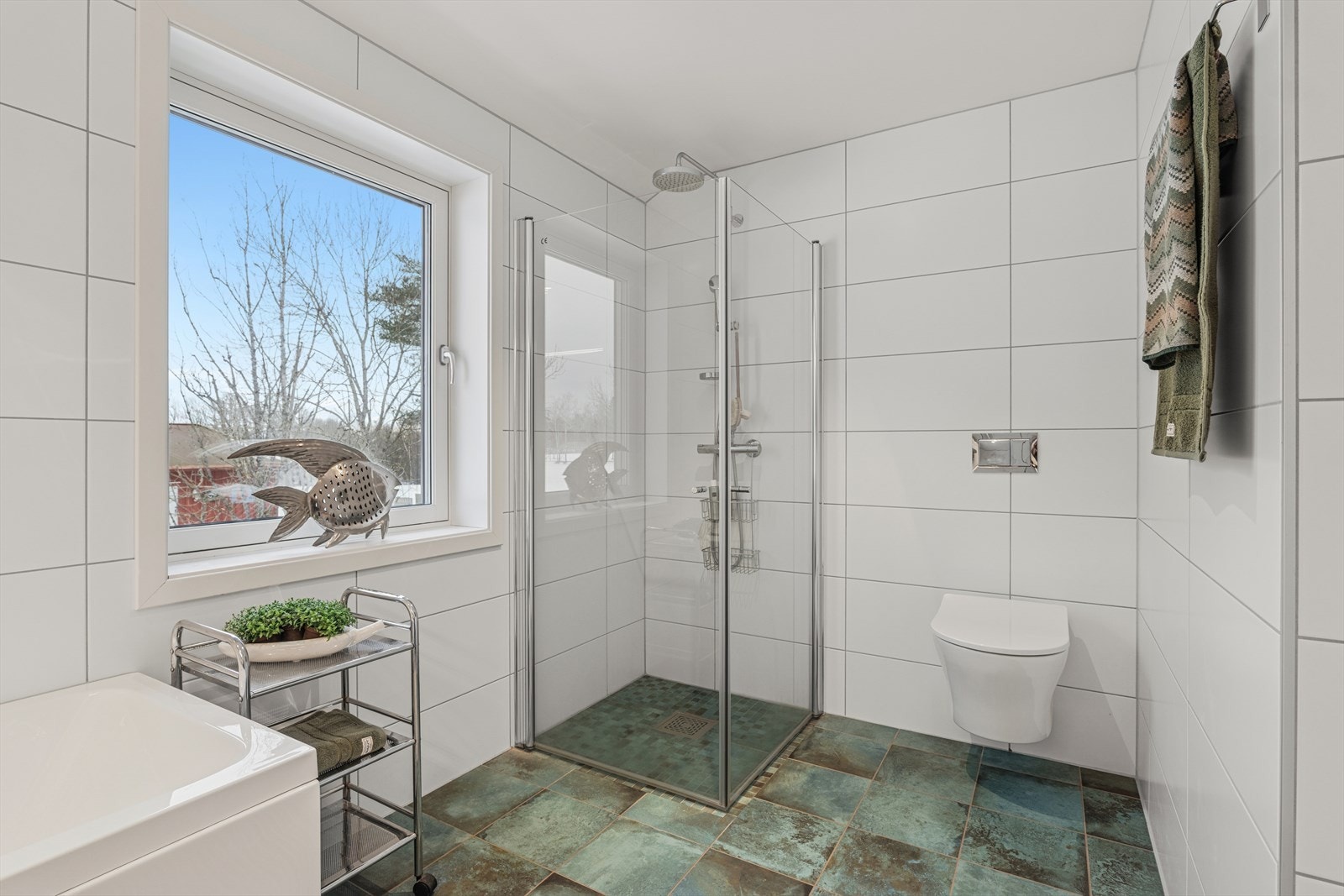 Hovedbadet er i tilknytning hovedsoverommet og er utstyrt med vegghengt toalett og dusjhjørne med glassdører. Galleribilde