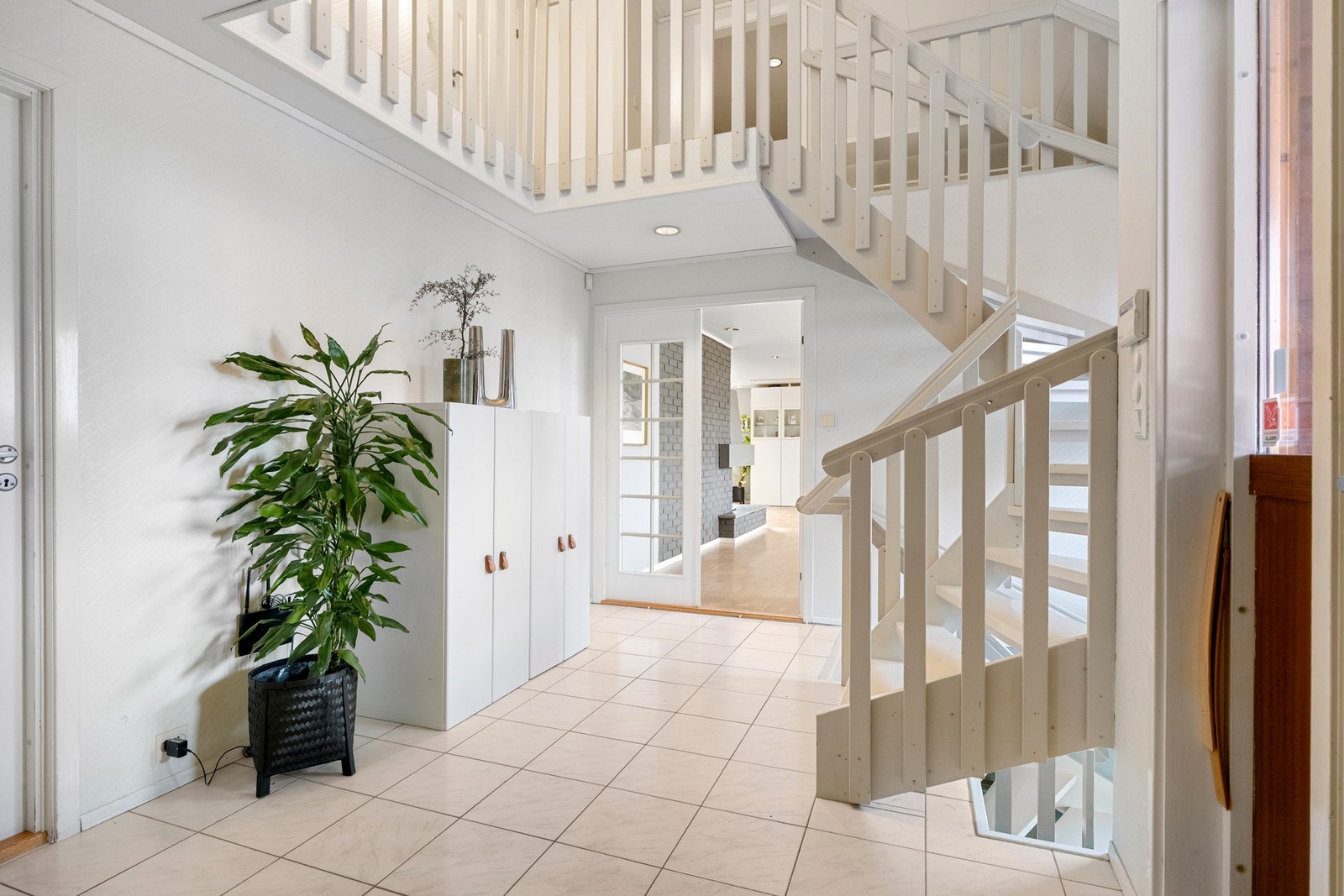 I første etasje blir du ønsket velkommen inn i en romslig entré med fliser på gulvet og lyse vegger som gir et godt førsteinntrykk. Galleribilde