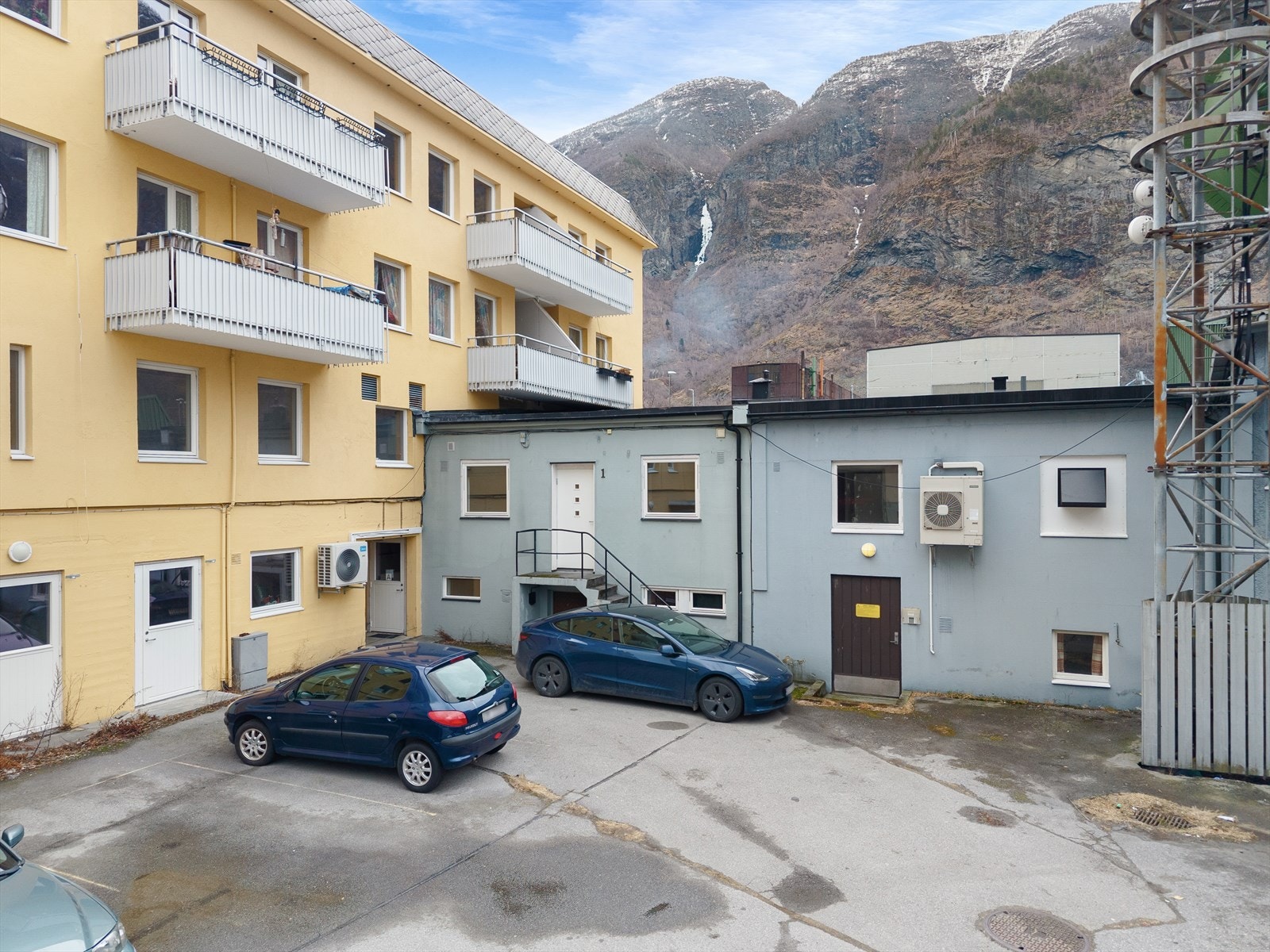 Biloppstillingsplass i bakgård med el-bil ladar. Galleribilde
