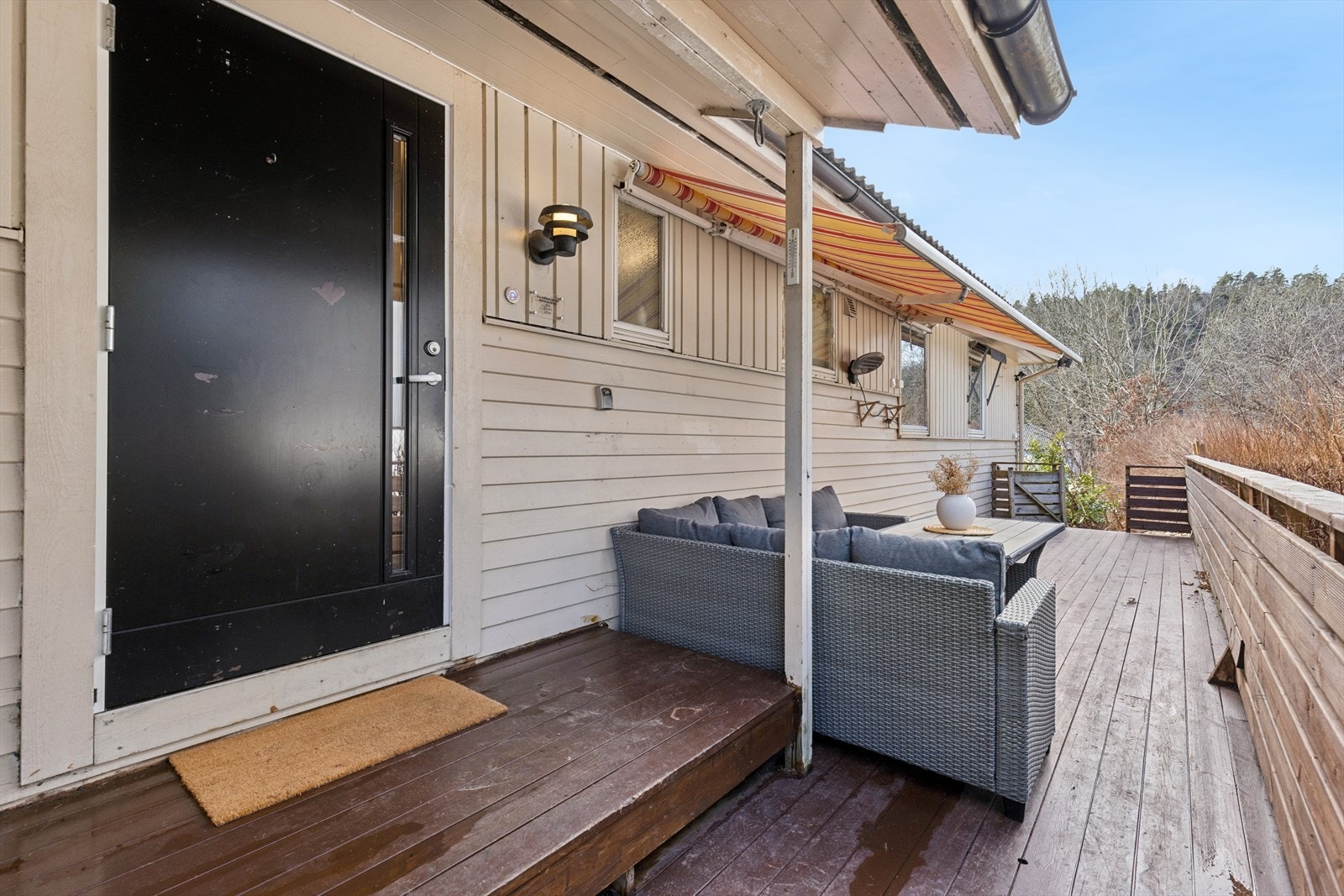 Boligens inngangsparti med en stor og solrik veranda. Galleribilde