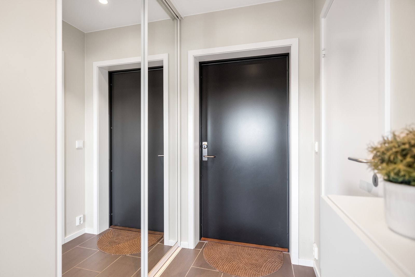 Flislagt entré med skyvedørsgarderobe. Galleribilde