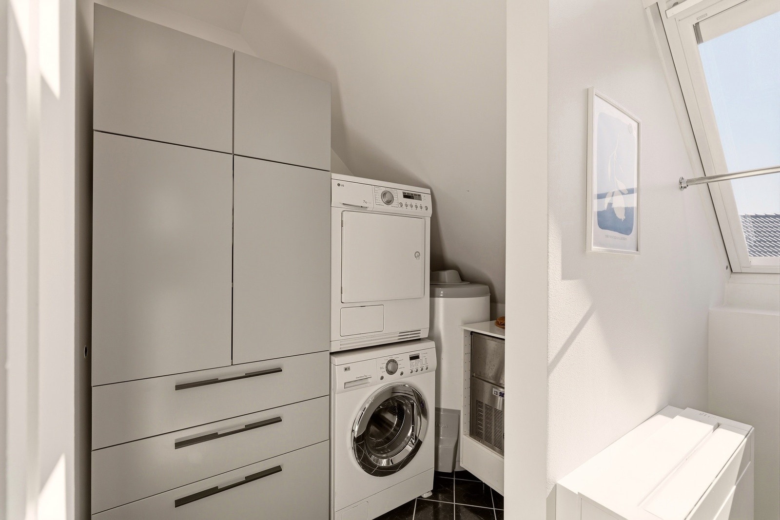 Kombinert vaskerom/bod/teknisk rom på øvre plan med varmtvannsbereder i hjørnet. Galleribilde