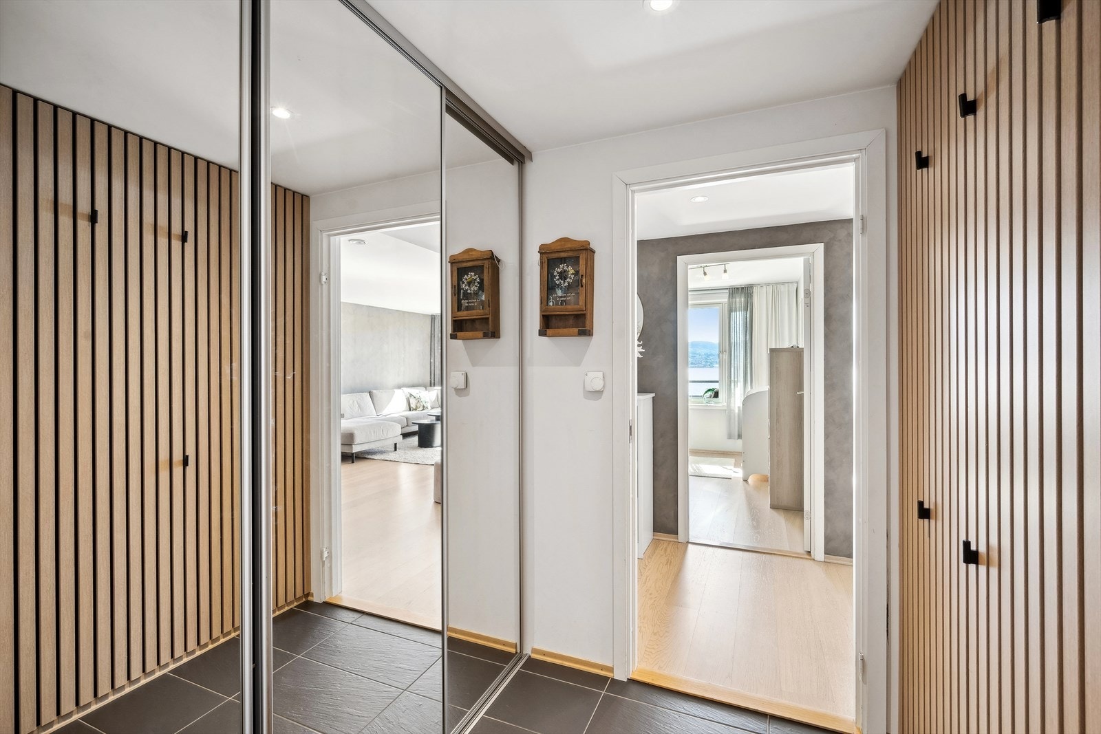 Innbydende entré med skyvedørsgarderobe og spilevegg. Galleribilde