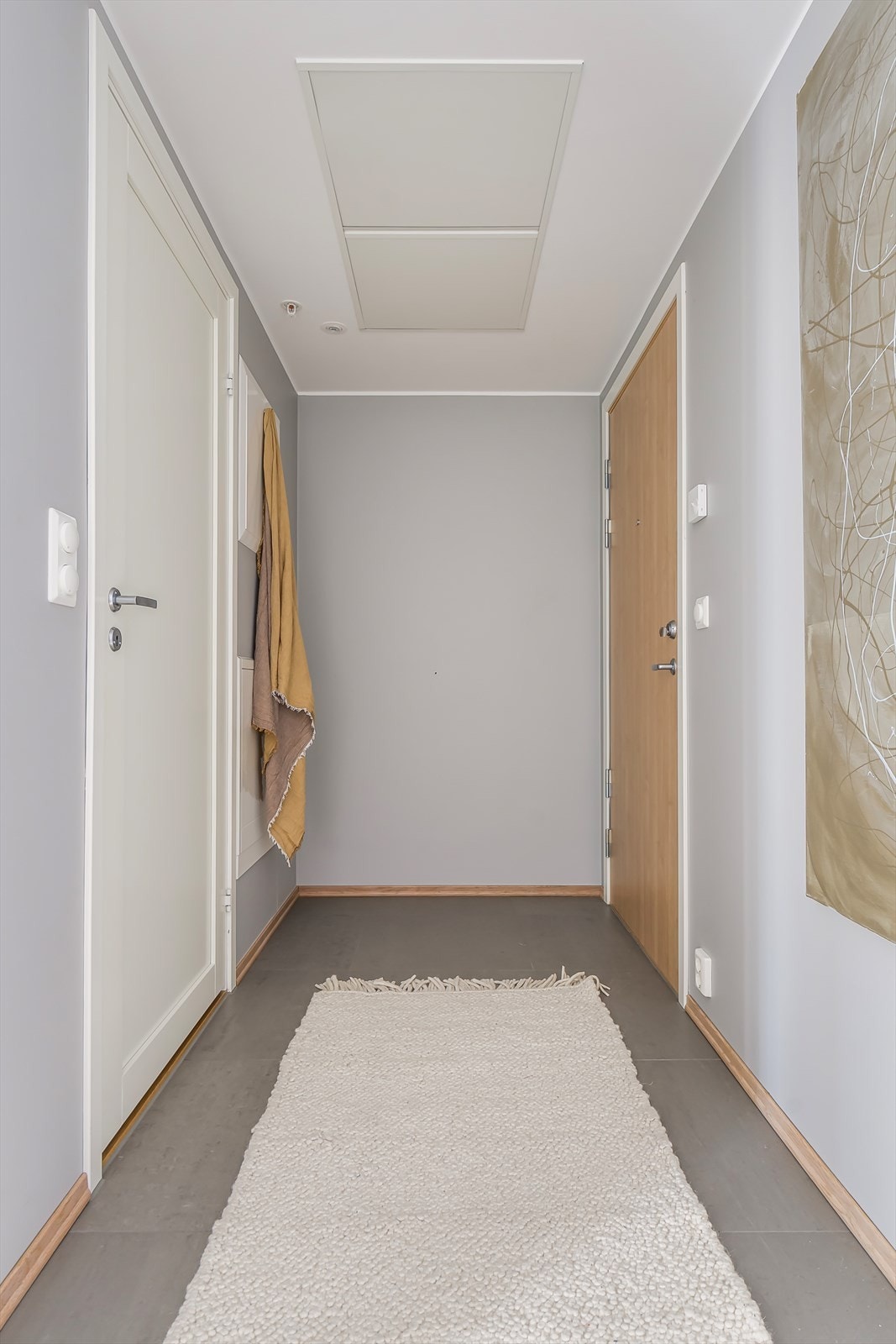 En praktisk entré med flislagt gulv og med plass for både jakker og sko. Galleribilde
