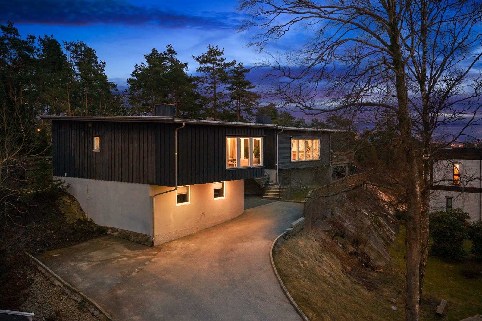 Fasaden har rette linjer, store vindusflater og en kombinasjon av treverk og glatte flater som gir et stramt, nordisk uttrykk. Galleribilde