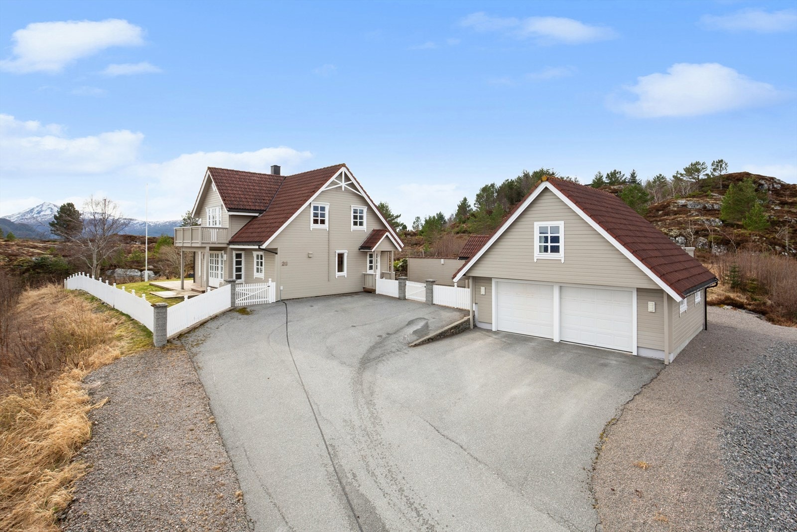 Enebolig med dobbelgarasje og romslig gårdsplass. Frittstående garasje fra 1999 på ca. 67 m² med innredet loft, oppgradert i 2022 og utstyrt med elektriske leddporter. Galleribilde