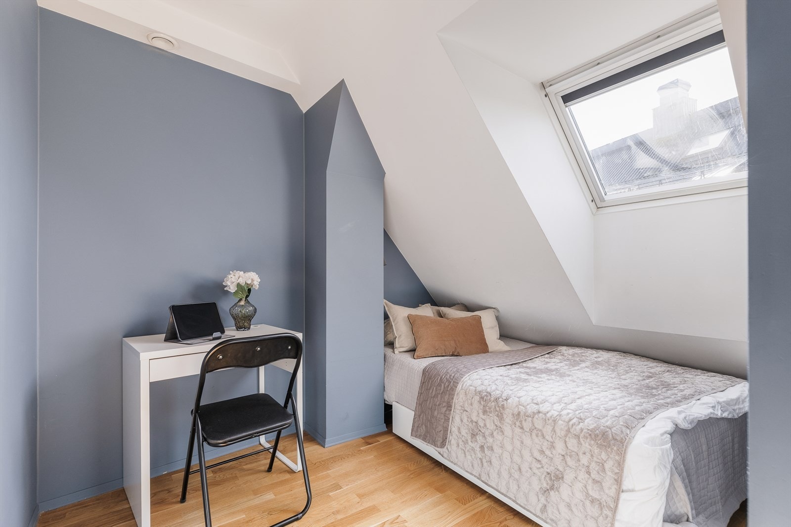 Praktisk og arealeffektivt soverom med skråtak og takvindu som gir godt lysinnslipp. Rommet har en lun og skjermet følelse, og egner seg godt som soverom, gjesterom eller hjemmekontor. Galleribilde