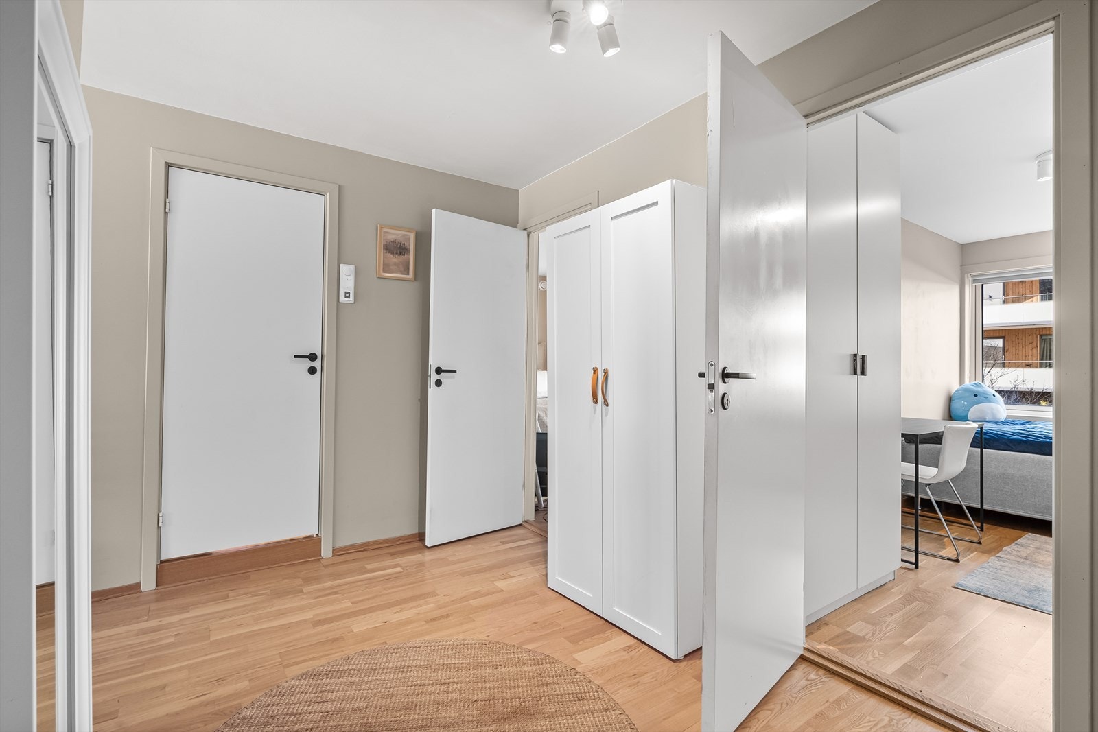 Entré med parkettgulv, malte veggflater og garderobeskap. Leiligheten har i tillegg gode oppbevaringsmuligheter i to kjellerboder Galleribilde