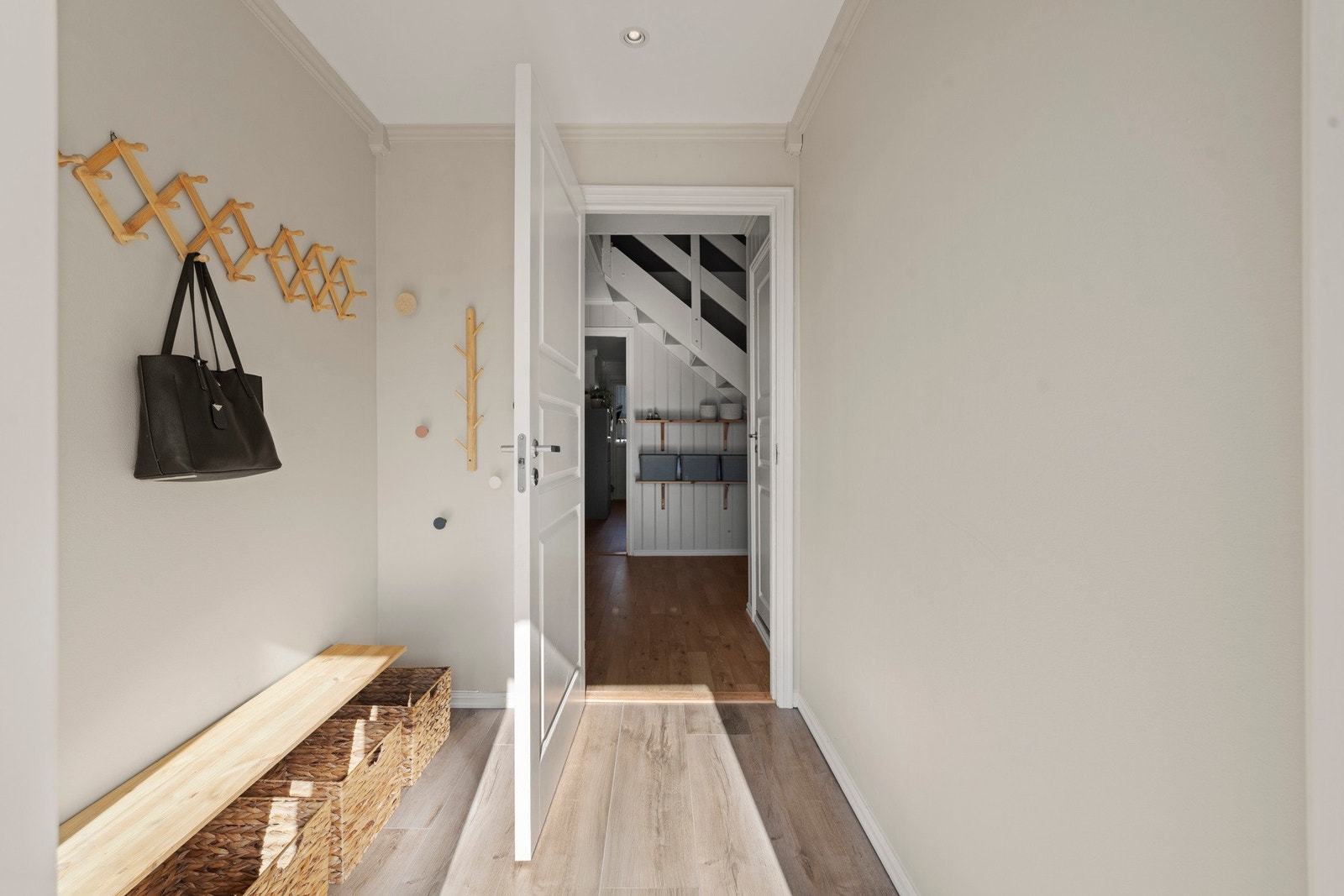 Entréen er lys og innbydende med moderne fargetoner og parkettgulv som går igjen gjennom hele boligen. Galleribilde
