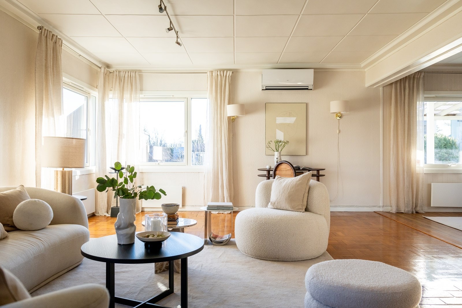 Gulvet er belagt med stavparkett lagt i kvadrat, og overflatene er malt i lyse fargetoner. Galleribilde