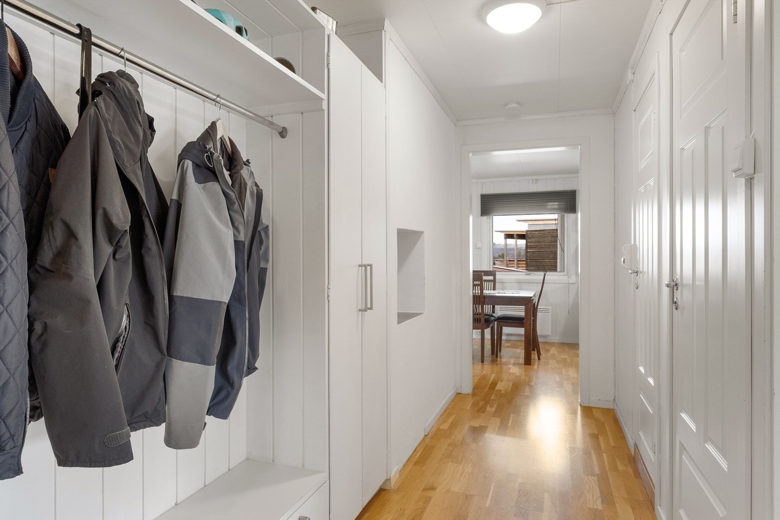 Entréen er lys og praktisk med god plass til både yttertøy og sko i en smart, åpen garderobeløsning med skuffer. Galleribilde