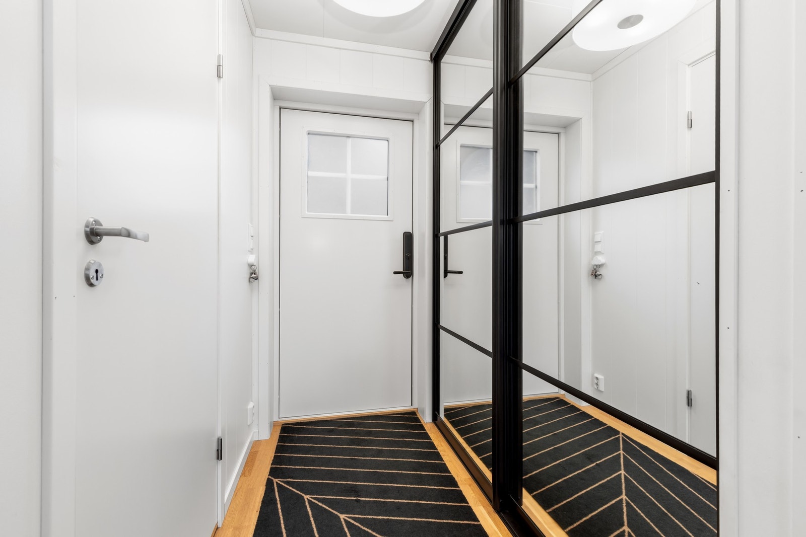Lys og innbydende entré/gang med praktisk skyvedørsgarderobe Galleribilde