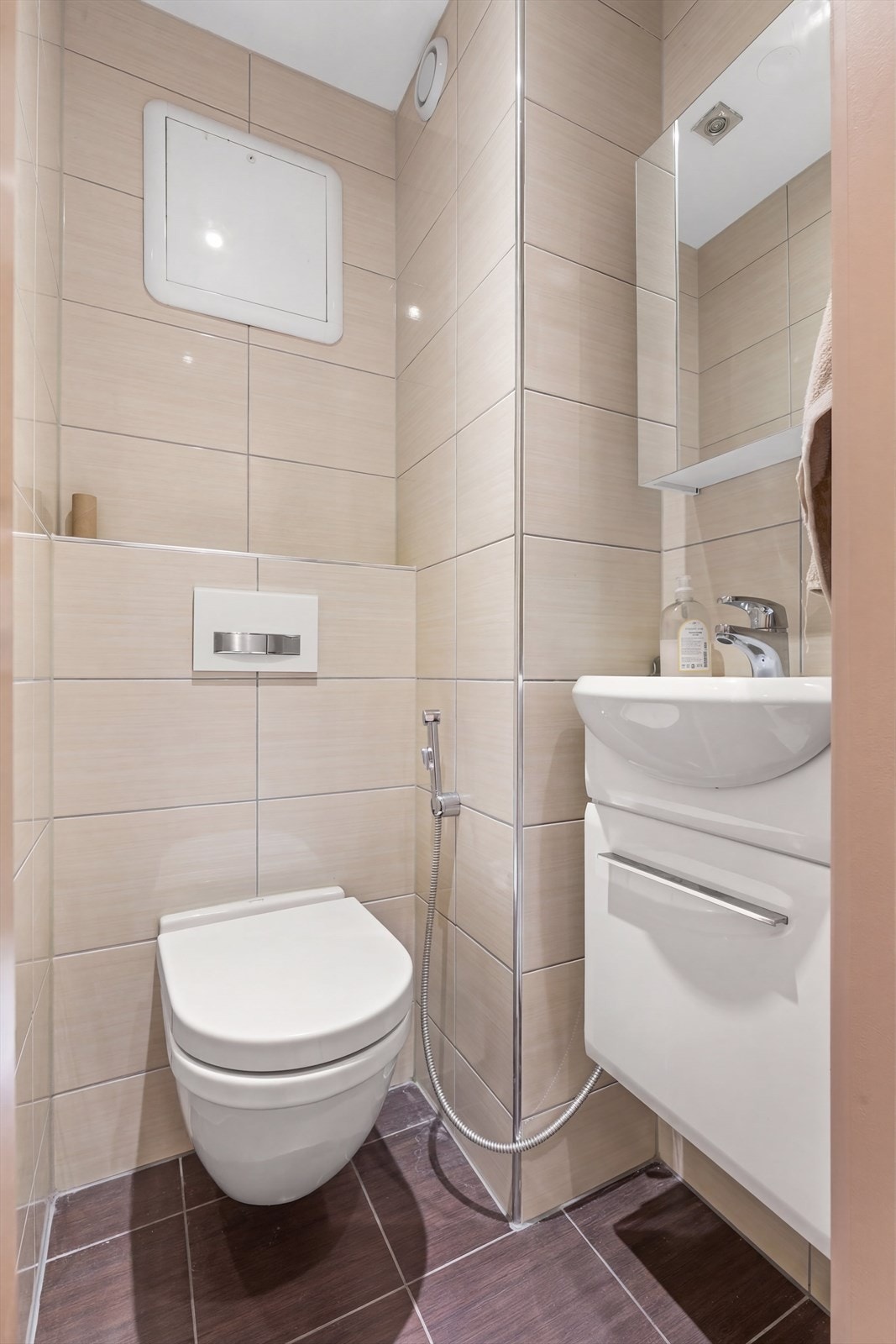 I tillegg til badet er det et separat toalettrom, også dette med fliser, vegghengt klosett og downlights. Perfekt som gjestebad når man har besøk. Galleribilde