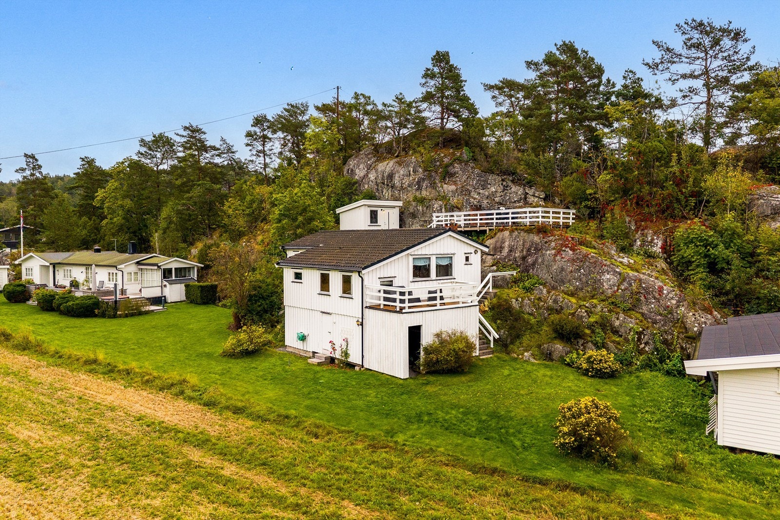 At hytta ligger inntil fjellet gir rom for uteplass på et nivå ovenfor hytta. Galleribilde