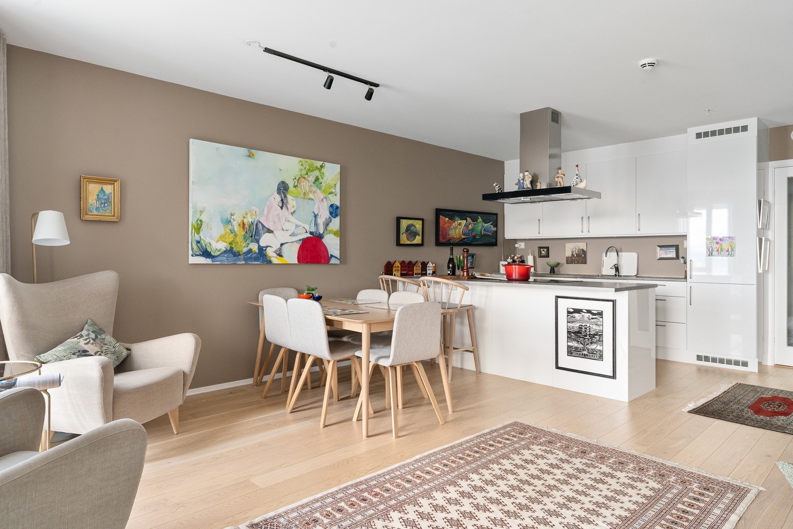 Lekkert kjøkken fra Nova med integrerte hvitevarer, takventilator og kjøkkenøy med mye lagringsplass.