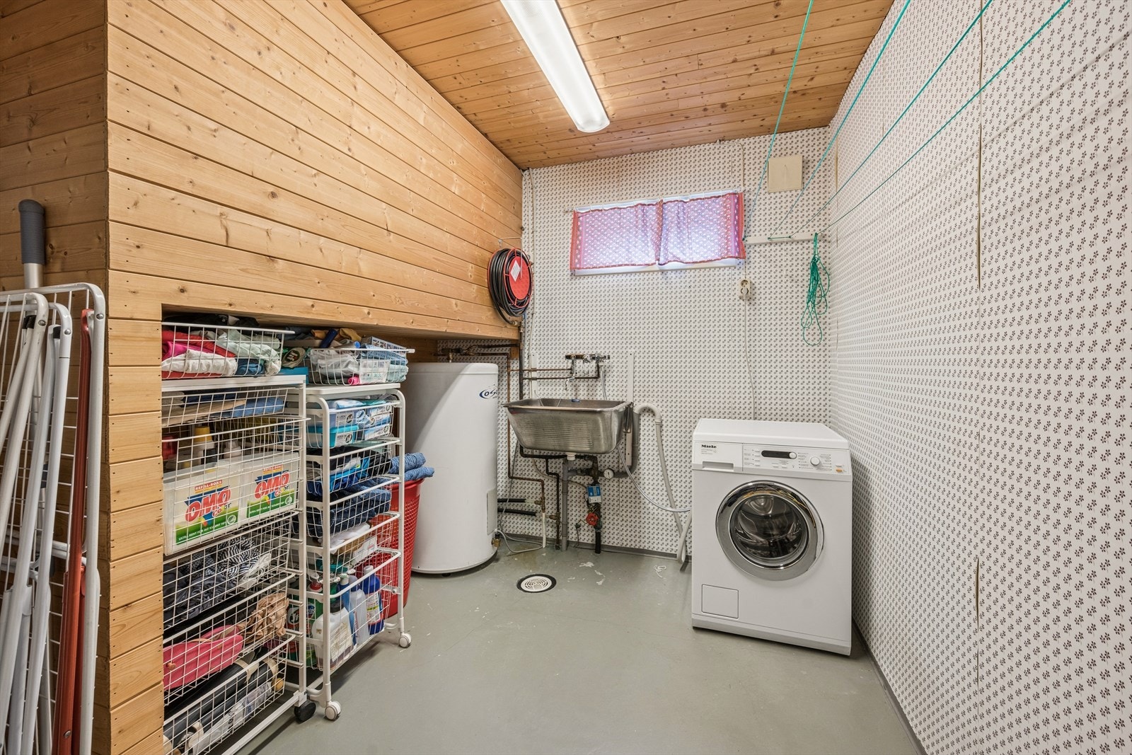 Praktisk vaskerom med opplegg for vaskemaskin, skyllekum og en 200-liters varmtvannsbereder. Galleribilde