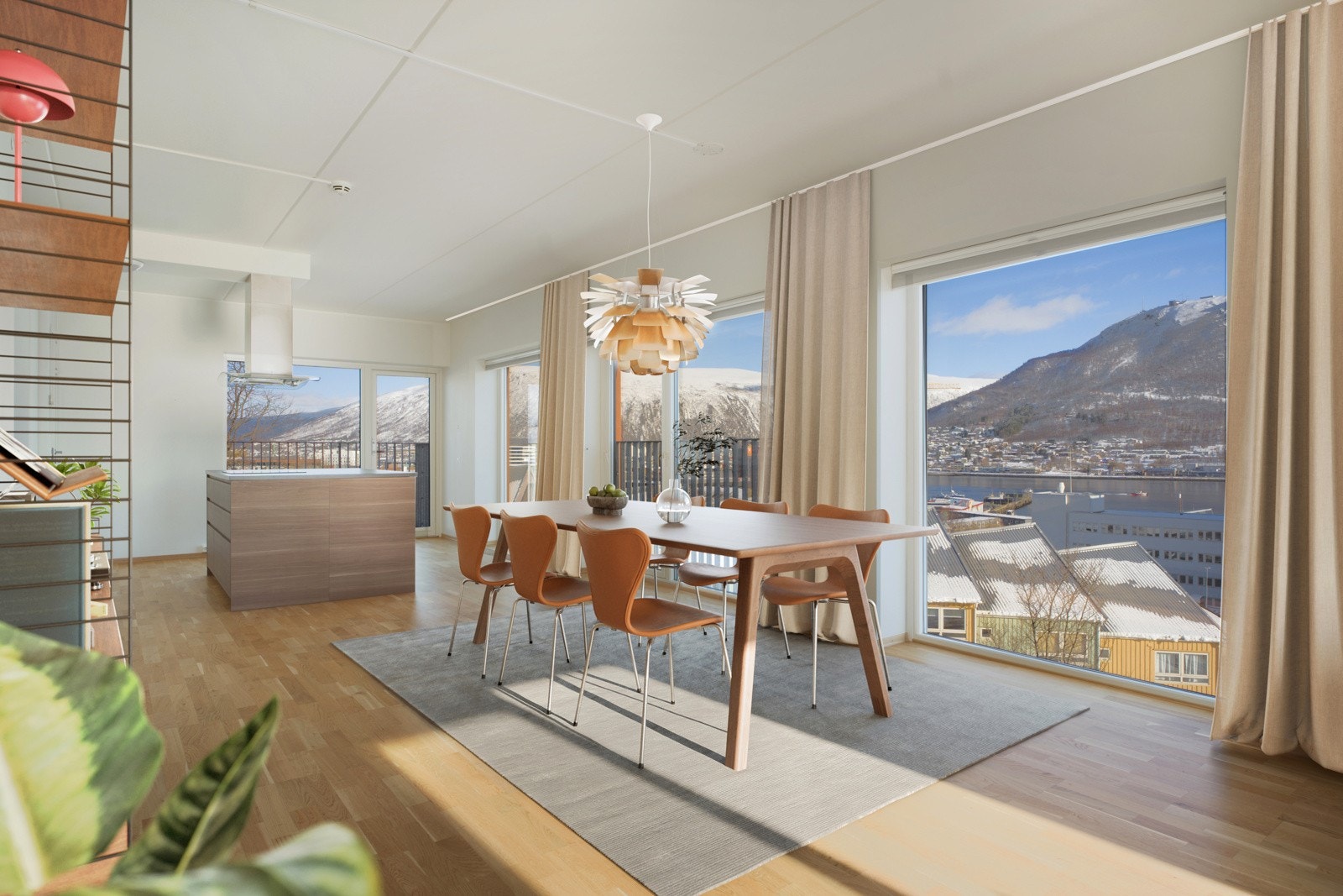 Stue og kjøkken i åpen løsning der med store vindusflater som sørger for god tilgang til den fenomenale utsikten!