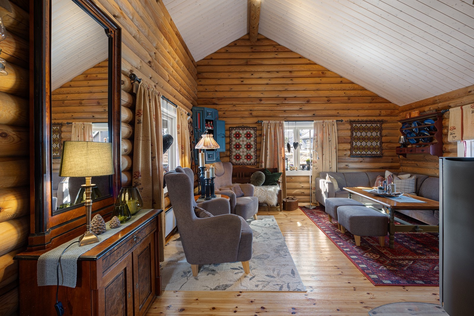 Dagslyset strømmer inn via store sprossevinduer i tre himmelretninger, og utsynet er naturskjønt. Galleribilde