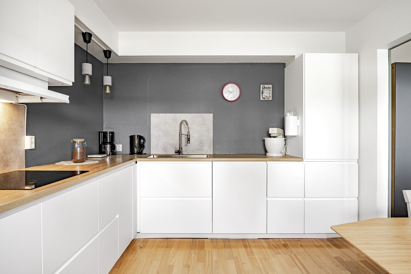 Innredningen har hvite glatte fronter og laminert benkeplate med nedfelt oppvaskkum. Medfølgende integrerte hvitevarer som nedfelt platetopp, stekeovn og micro i høyskap, oppvaskmaskin, kjøl og frys. Galleribilde