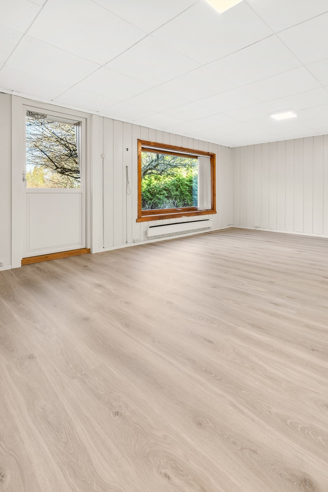 Stuen oppleves lys og åpen med store vindusflater som slipper inn rikelig med dagslys og gir en luftig romfølelse. Galleribilde