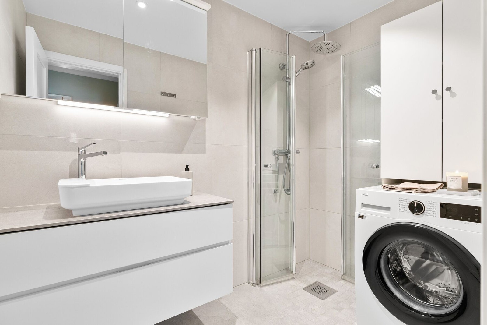 Delikat flislagt bad fra 2022/23 med downlights i himling og behagelig varme i gulv. Badet er utstyrt med dusjhjørne, opplegg for vaskemaskin og innredning med rikelig av oppbevaringsplass. Galleribilde