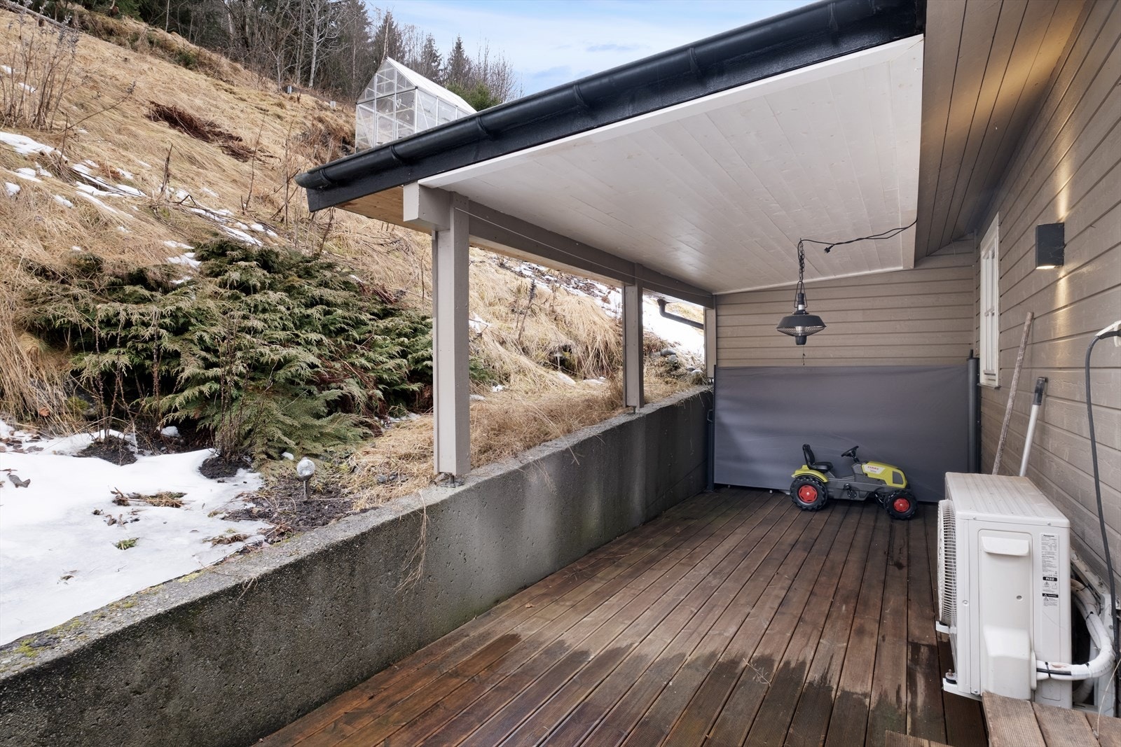 Skjerma overbygd terrasse i bakkant av bustaden. Galleribilde