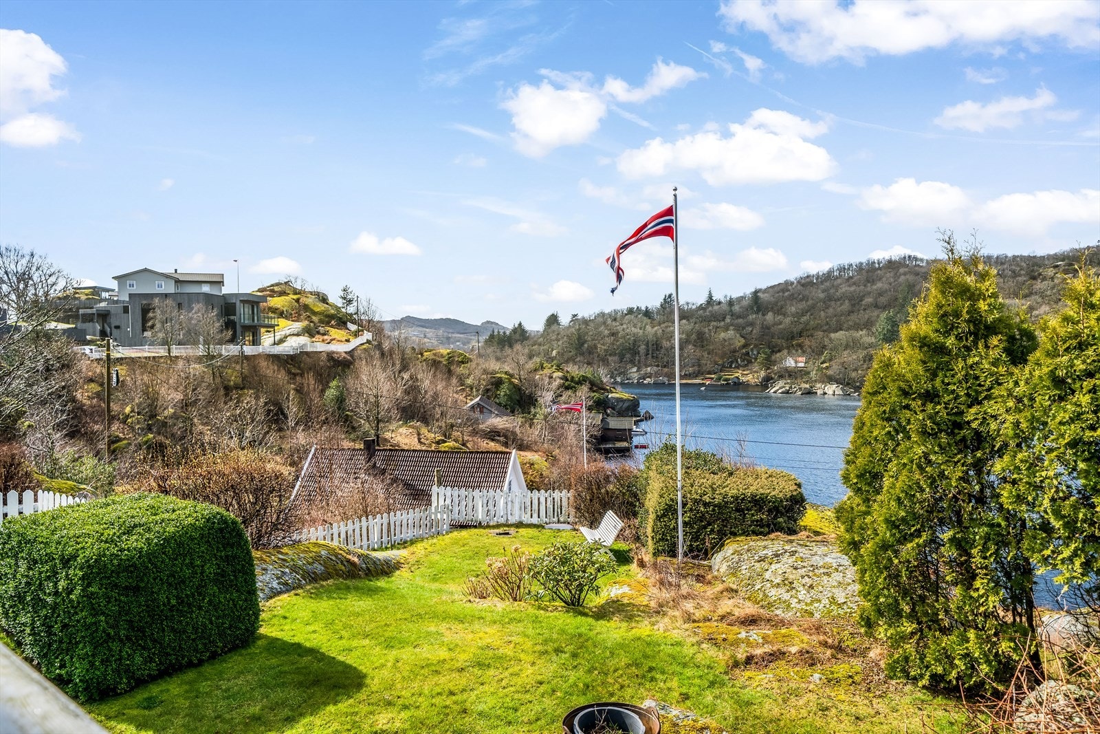 Pent opparbeidet hage med idyllisk hvitt stakittgjerde Galleribilde
