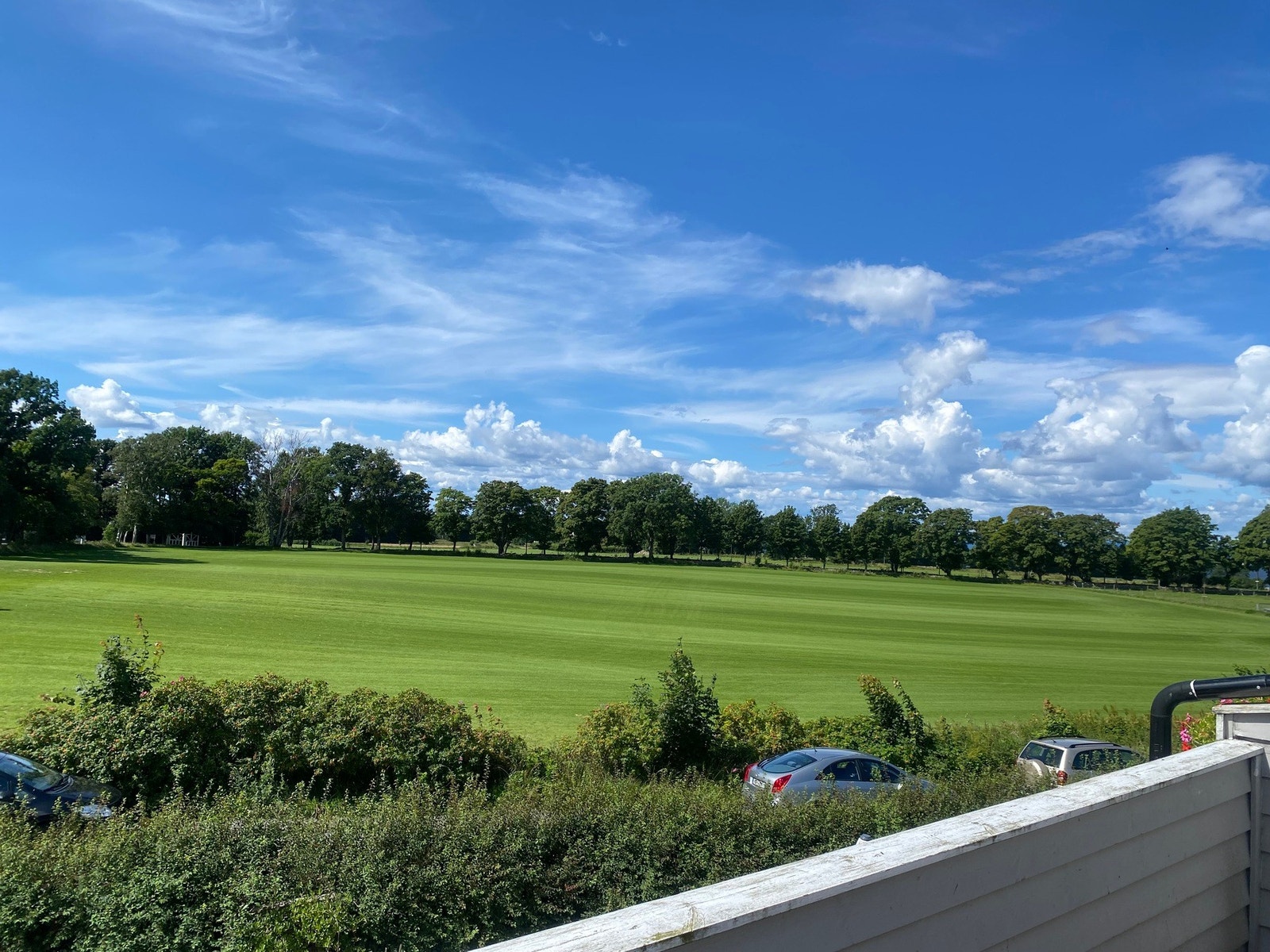 Utsyn til jorder, alleer og sjø. Privat sommerbilde. Galleribilde