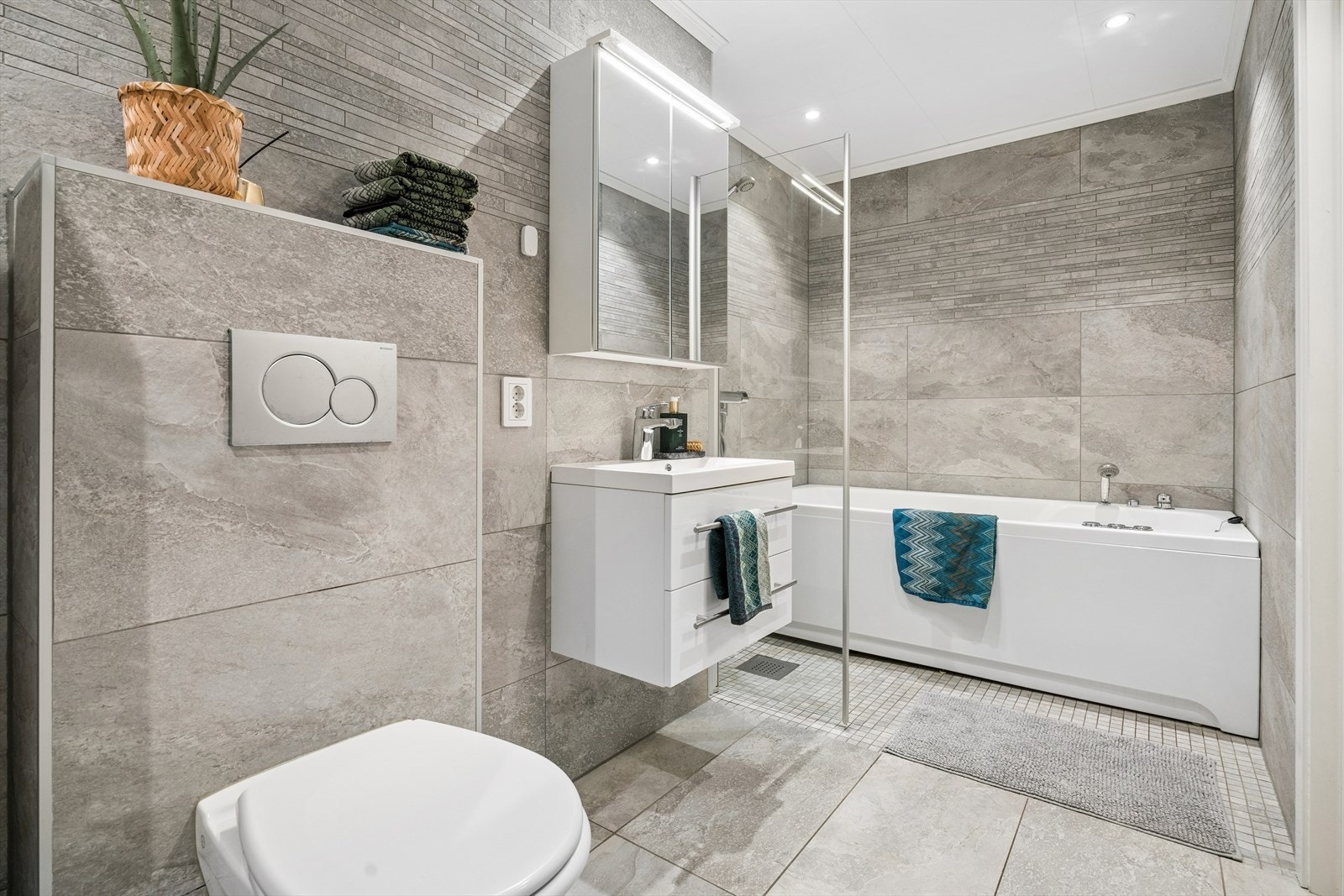 Lekkert og delikat flislagt bad fra 2015. Her er det behagelige varmekabler i gulv. Badet er utstyrt med et herlig boblebadekar med dusjløsning. Galleribilde