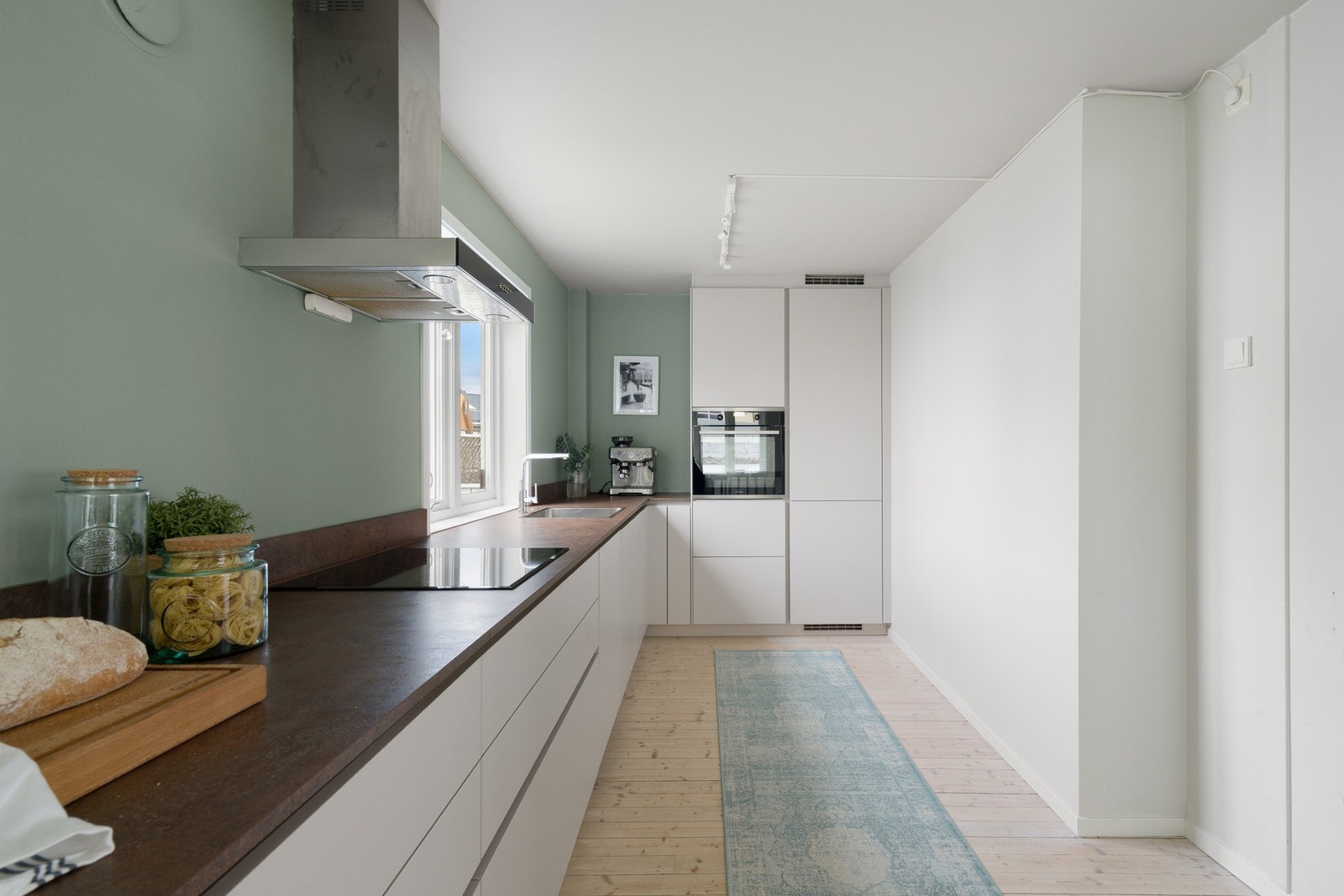 For et luftigere uttrykk er overskap droppet til fordel for åpne flater, men det er likevel rikelig med både skap- og benkeplass på kjøkkenet. Galleribilde