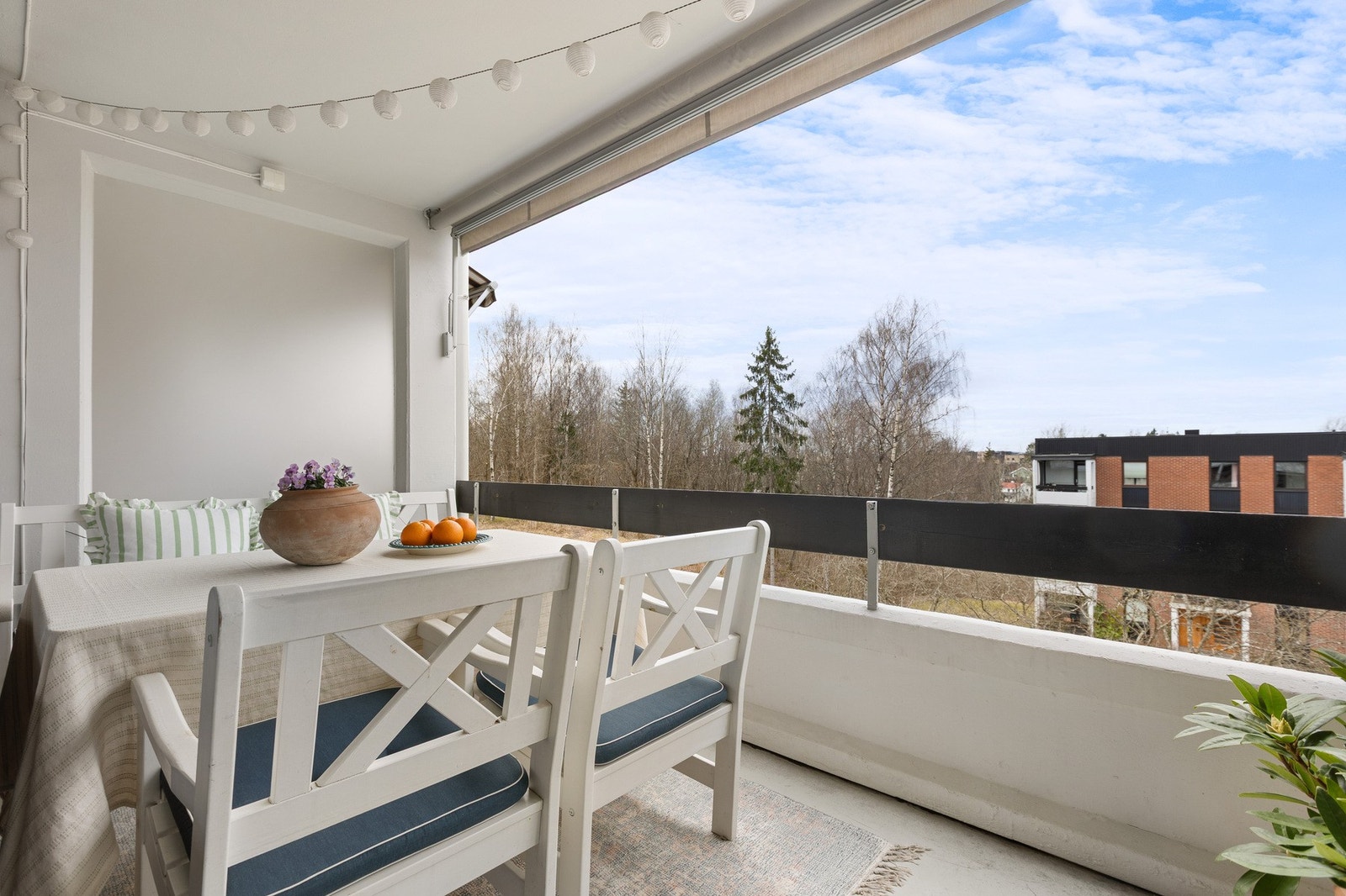Utsikten går mot skog og lekeplass, og om våren blomstrer trærne langs gresset i rosa. Galleribilde