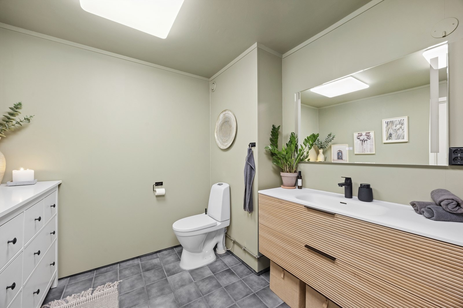 Badet har flislagt gulv med varmekabler. Innredning og toalett er nytt fra 2024. Galleribilde