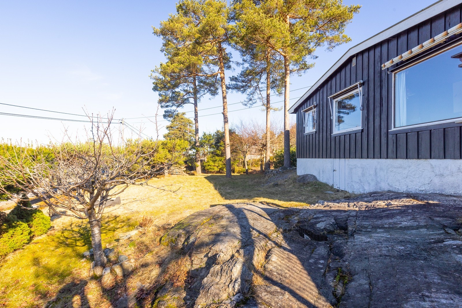 Tomten består av en blanding av plen, naturtomt og synlig fjell. Galleribilde