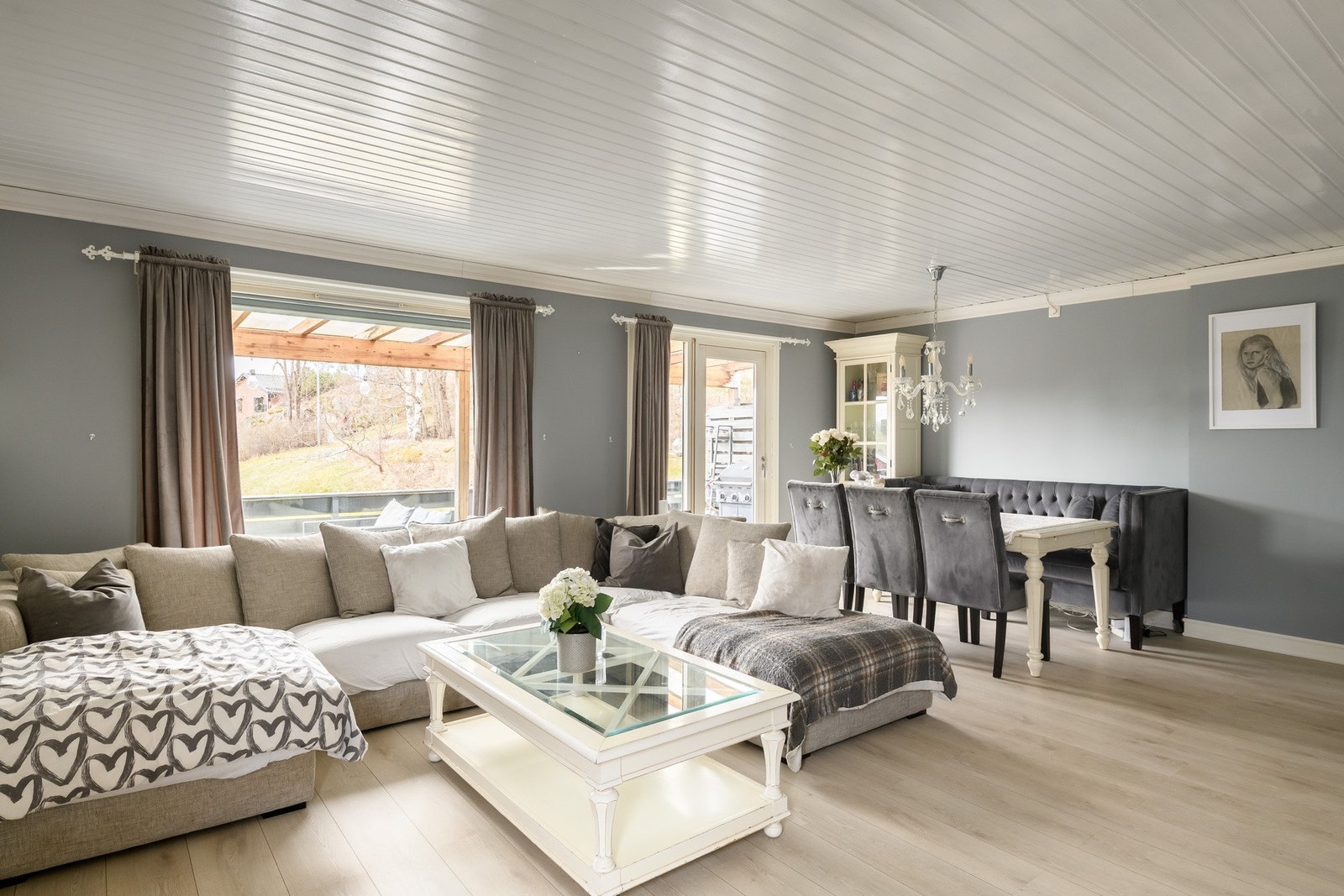 De gråmalte veggene står godt til det lyse, tidsmessige laminatgulvet. Galleribilde