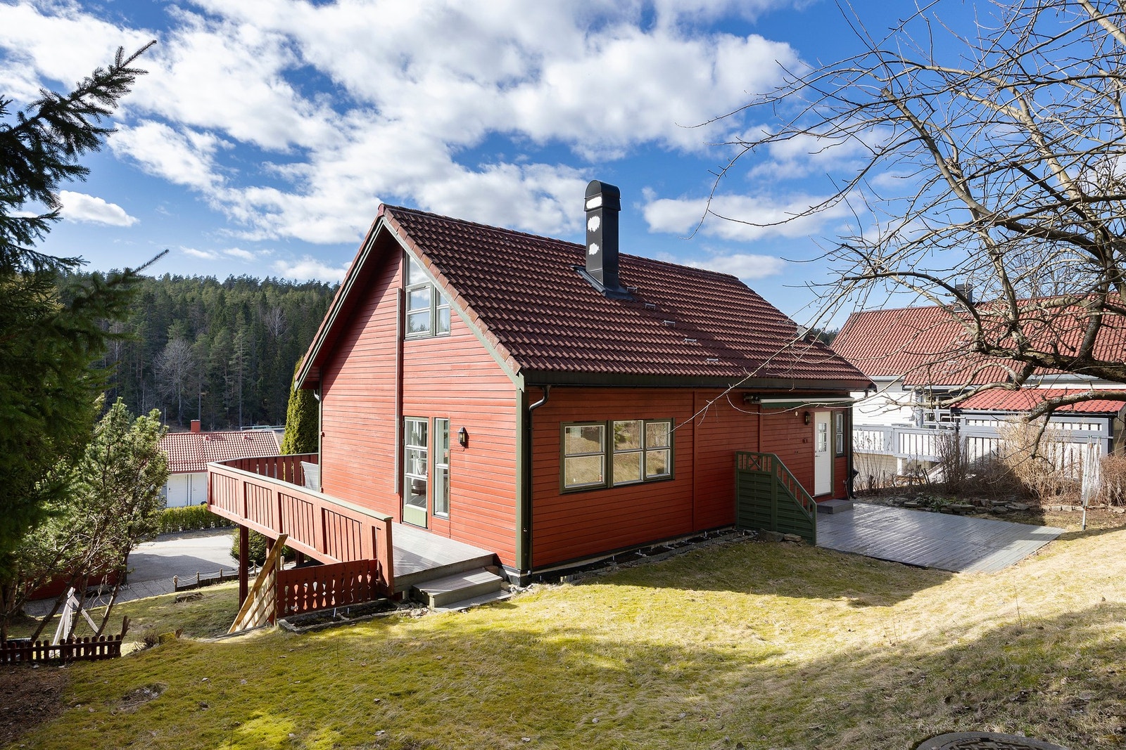 Boligens bakside har stor plen og adkomst fra blant annet verandaen. Galleribilde