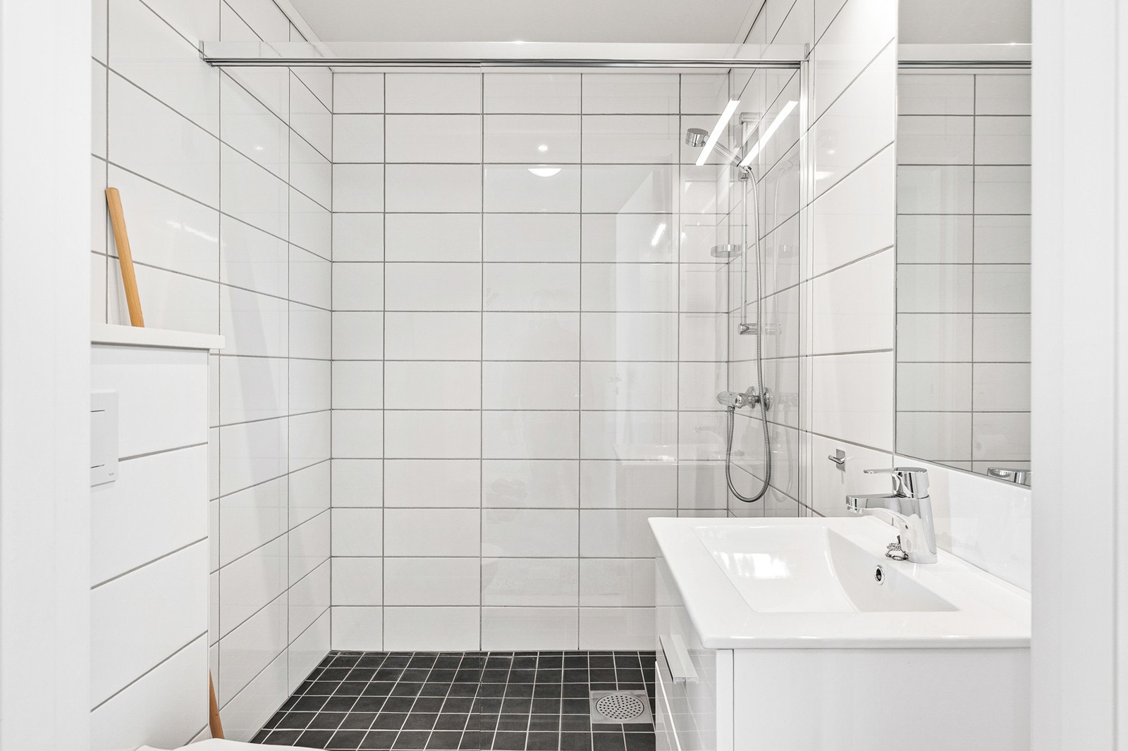 Badet er innredet med dusjhjørne, vegghengt toalett og
baderomsinnredning med vask Galleribilde
