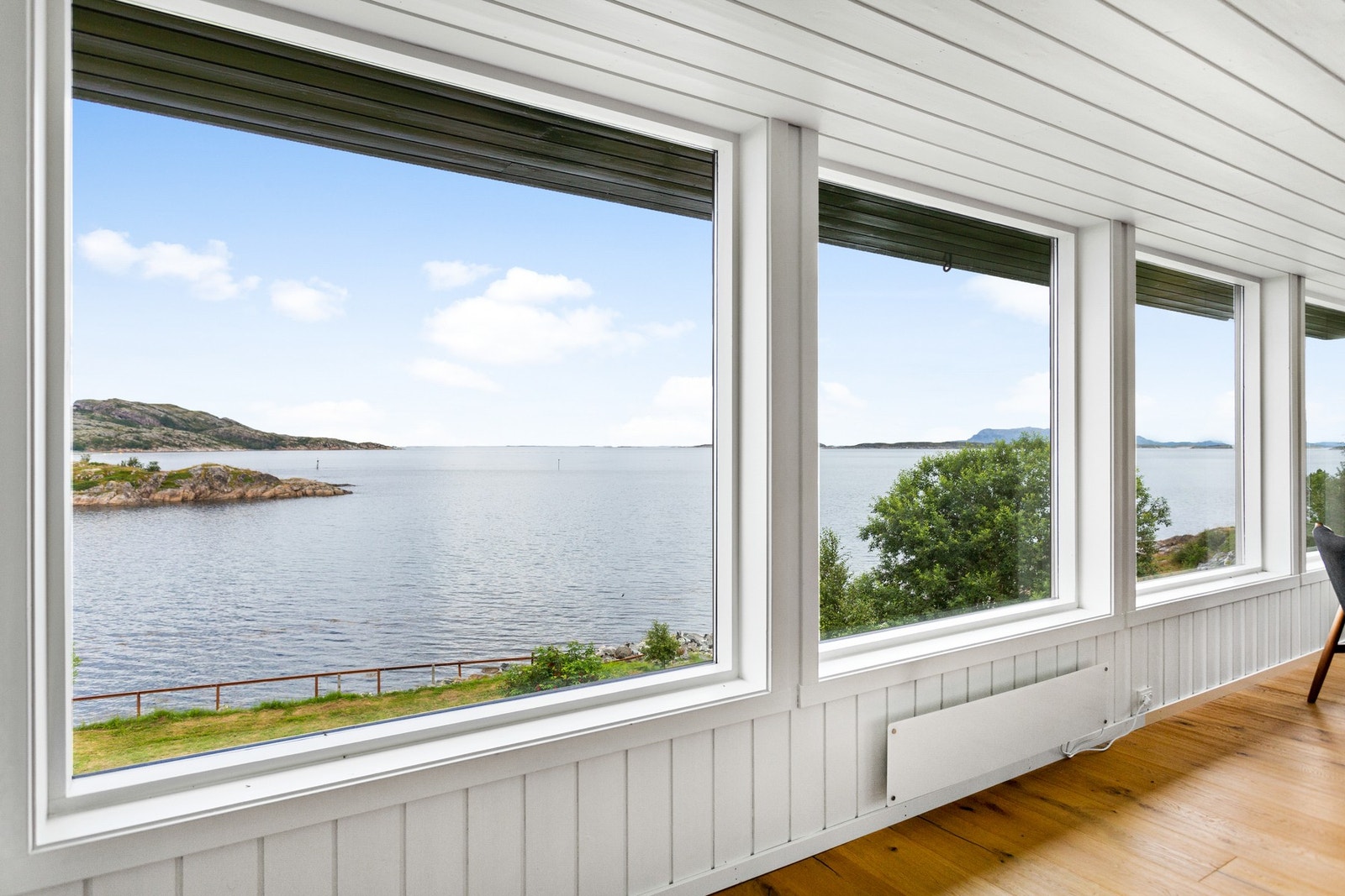 Store vindusflater som lar lys og utsikt bli en naturlig del av rommet Galleribilde