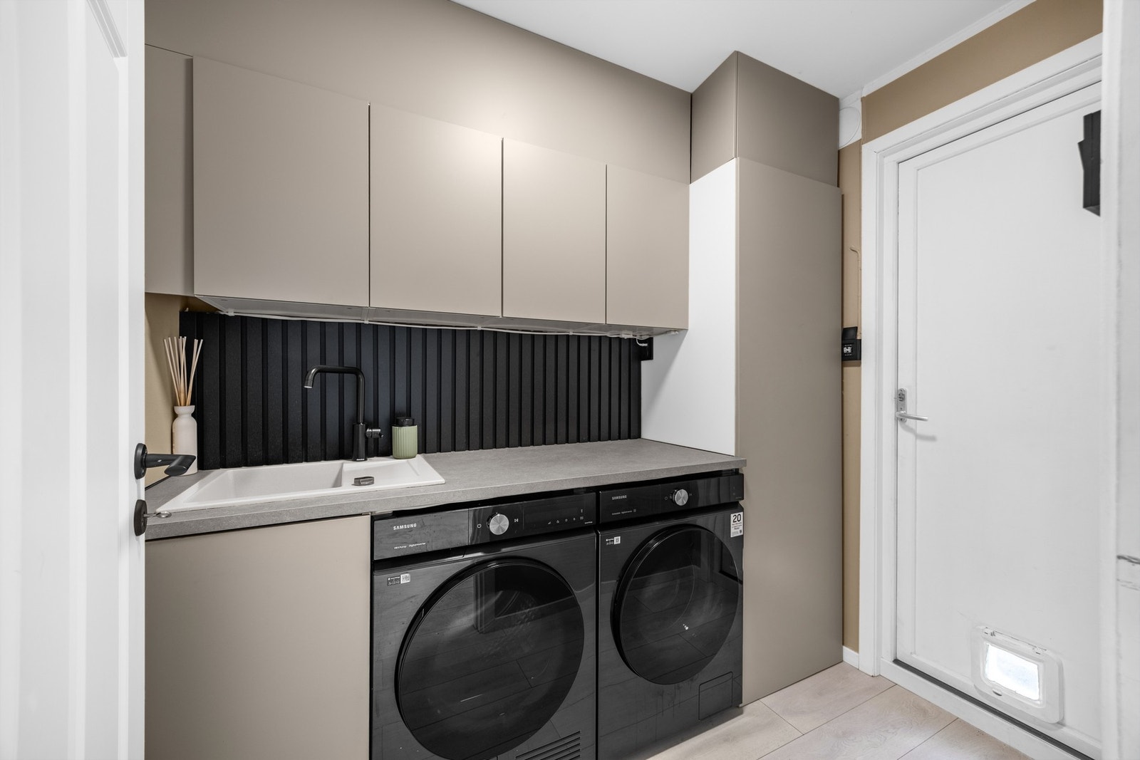 Vaskerommet byr på gode oppbevaringsmuligheter og er praktisk innredet med laminat benkeplate og nedfelt kum. Det er tilrettelagt for både vaskemaskin og tørketrommel. Galleribilde
