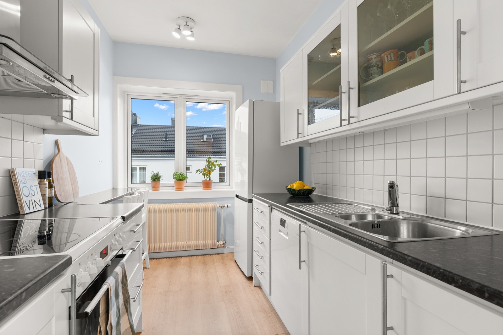 Kjøkkeninnredning fra 2006 med profilerte hvite fronter. Galleribilde