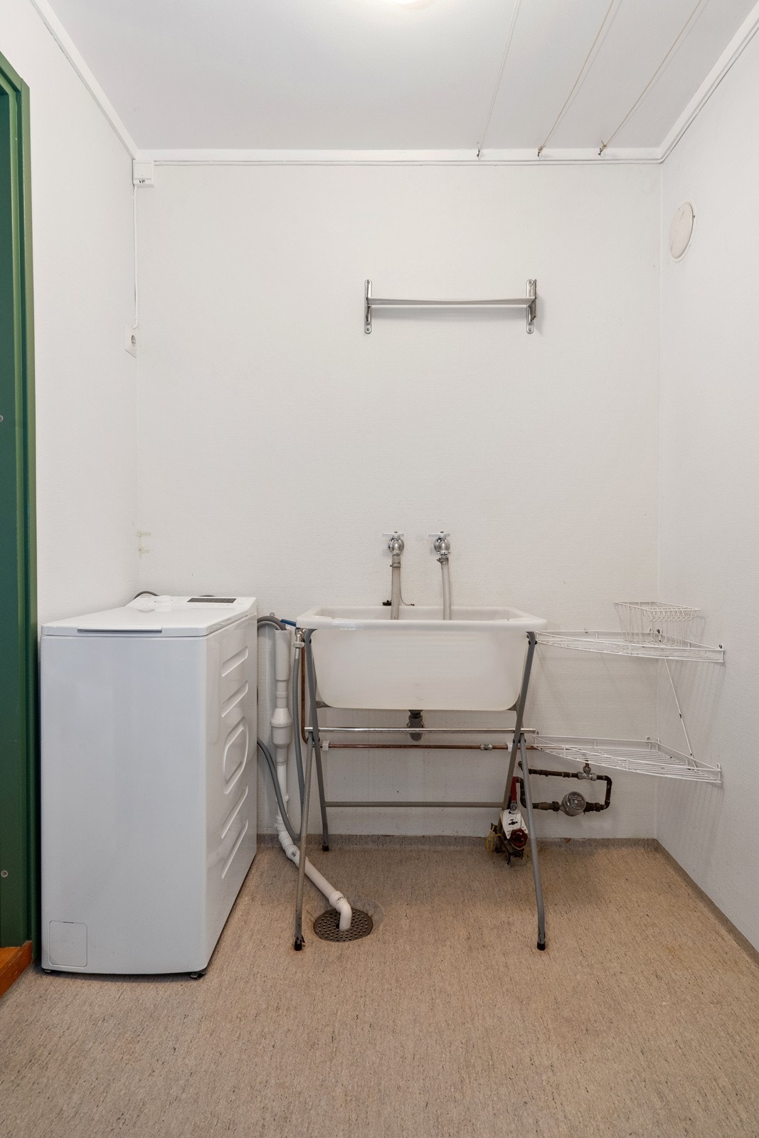 Separat vaskerom i sokkeletasjen med utslagskum og opplegg for vaskemaskin. Galleribilde