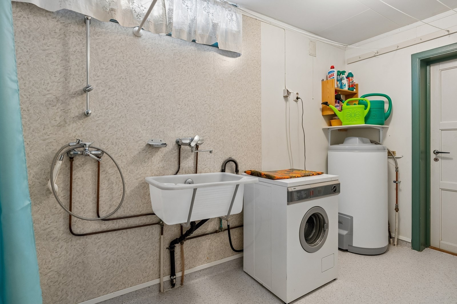 Vaskerommet har gulvbelegg og vegger med plater/tapet, og er utstyrt med opplegg for vaskemaskin, vaskekum i plast, varmtvannsbereder og veggmontert dusj. Galleribilde