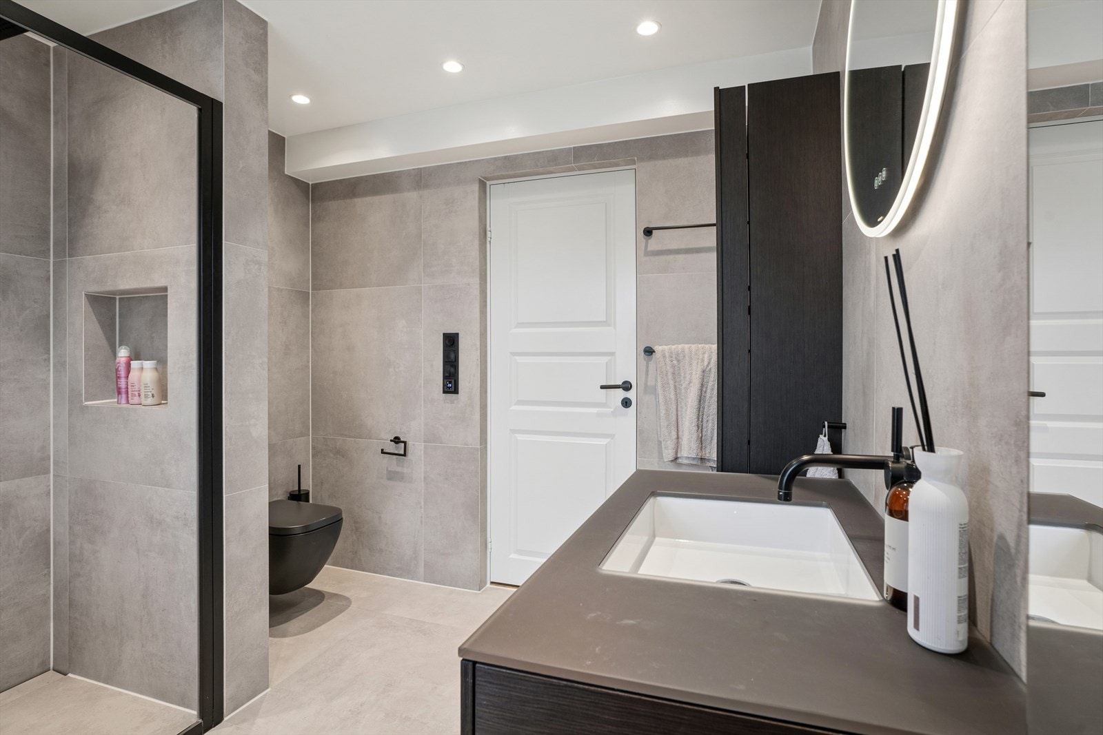 Badet er utstyrt med gulvvarme, vegghengt toalett og en romslig dusjsone med dobbeldusj. Galleribilde
