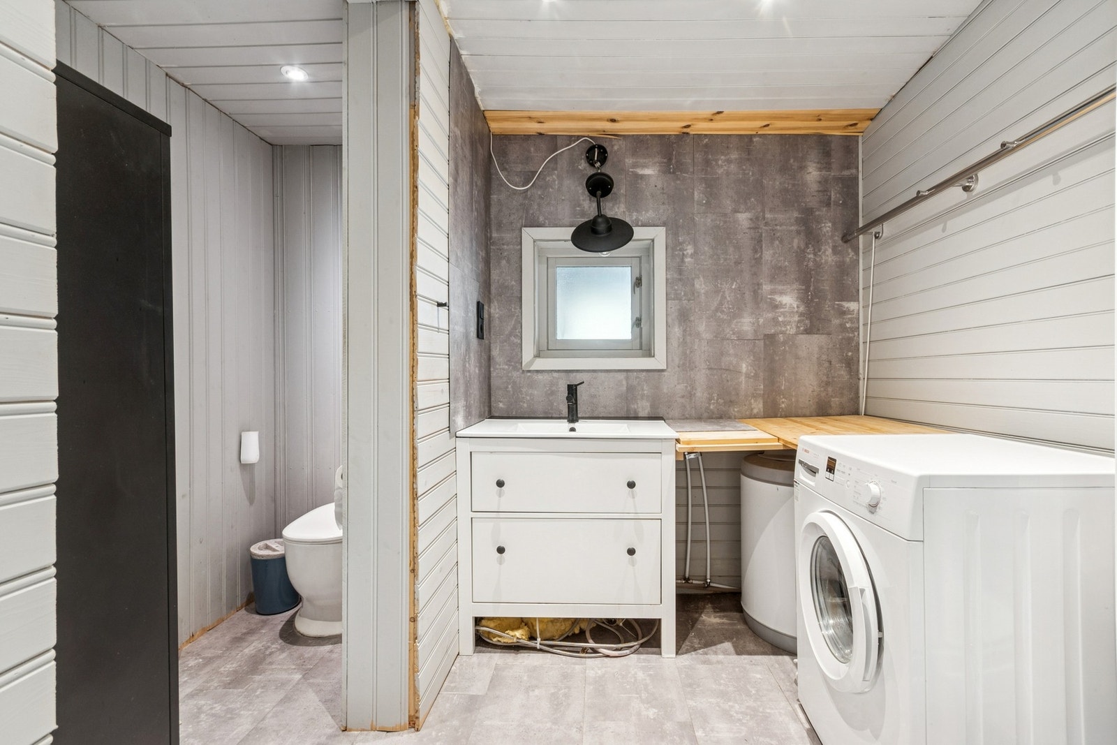 Badet har gulv av vinylbelegg, veggene har malt panel og baderomsplater, og det er panel i taket. Galleribilde