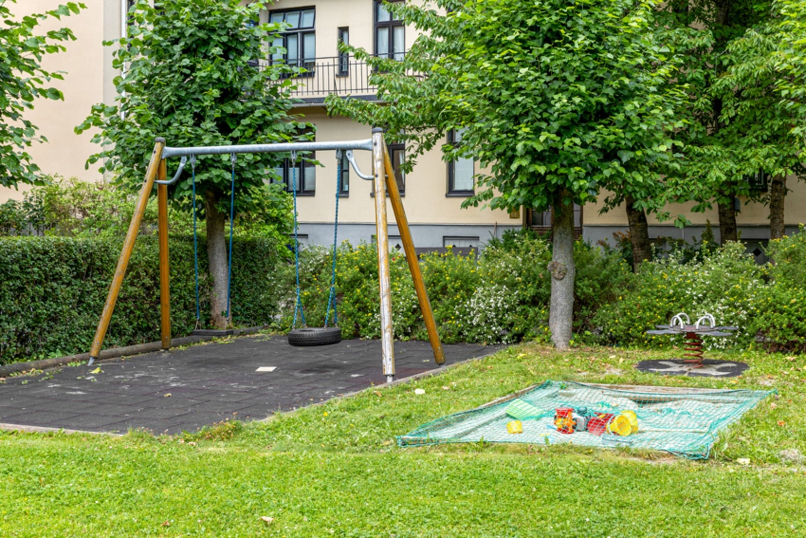 Bakgården er pent opparbeidet med flott beplantning av blomster, busker og trær. Galleribilde