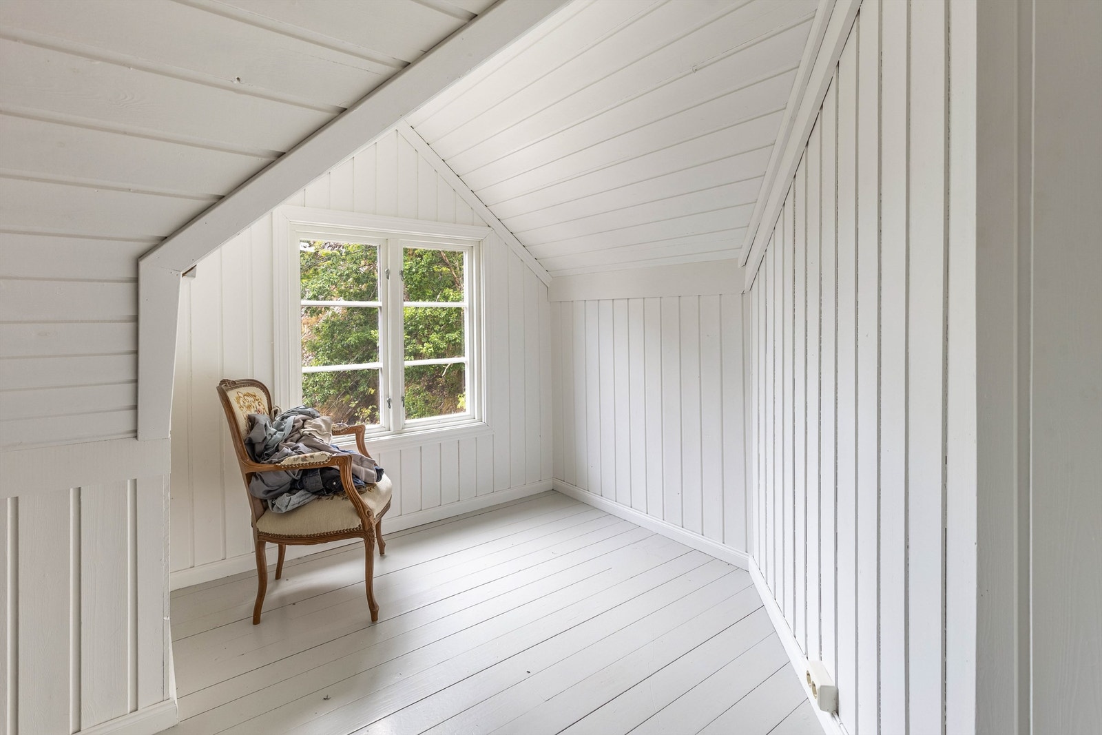 Loftsetasjen har et klassisk eldre uttrykk med lyst treverk på vegger, tak og gulv. Galleribilde