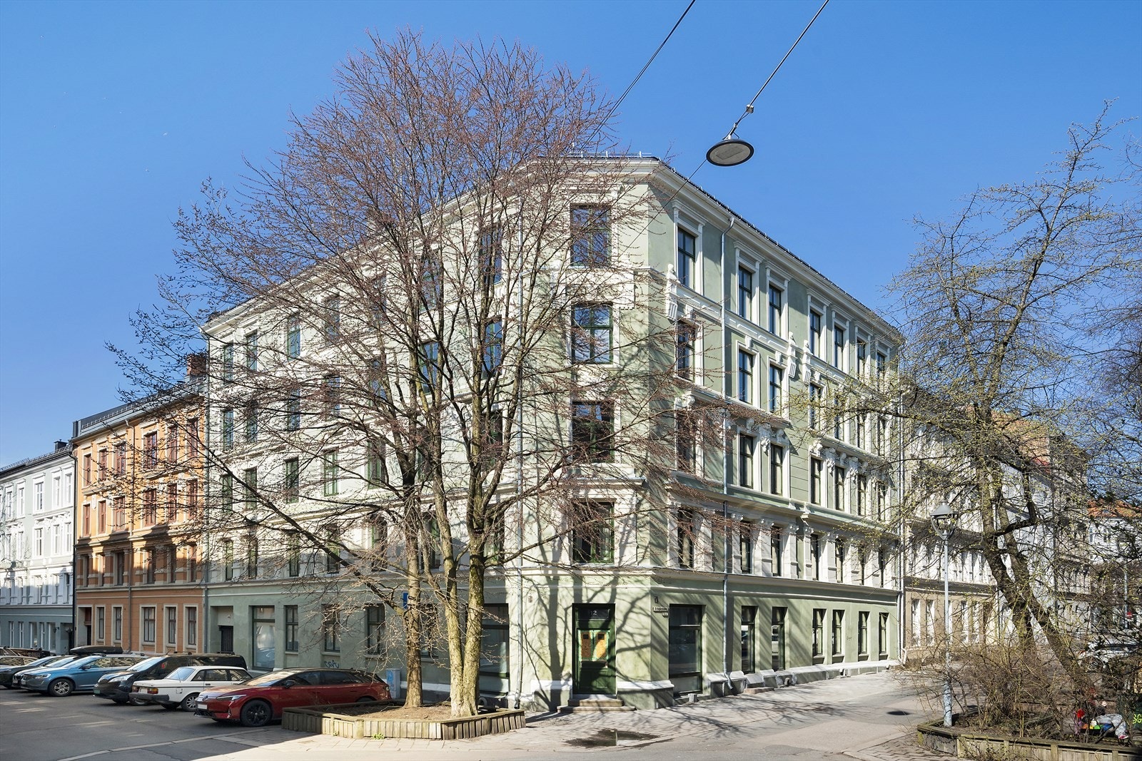 Hjørnegård fra ca. 1900 i murkonstruksjon med pussede og malte fasader Galleribilde