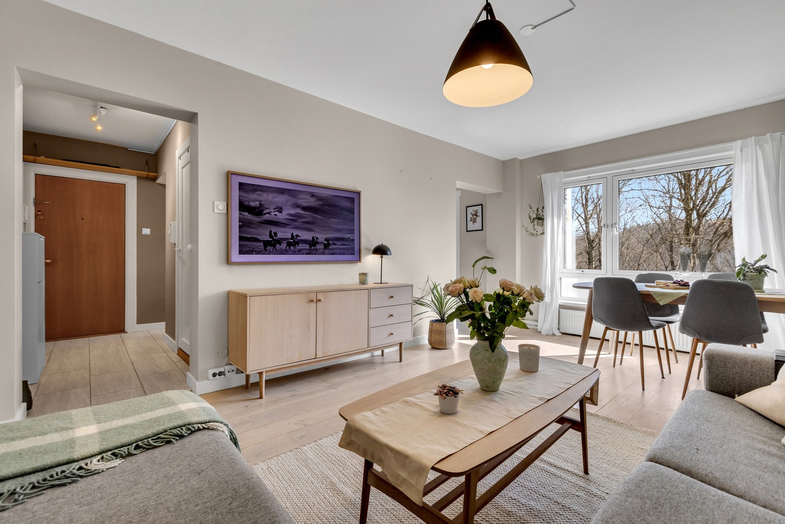 Lys og romslig stue med store vindusflater og god plass til både sofa og spisebord. Galleribilde
